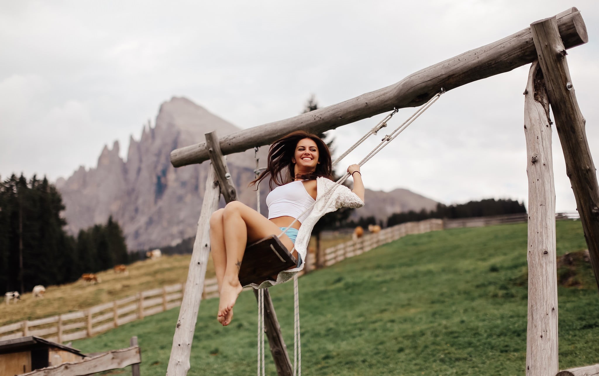 white tops, brunette, lifestyles, sitting, portrait, women outdoors, smiling, land, short shorts, plant, white, real people, young adult, nature, swings, HD Wallpaper