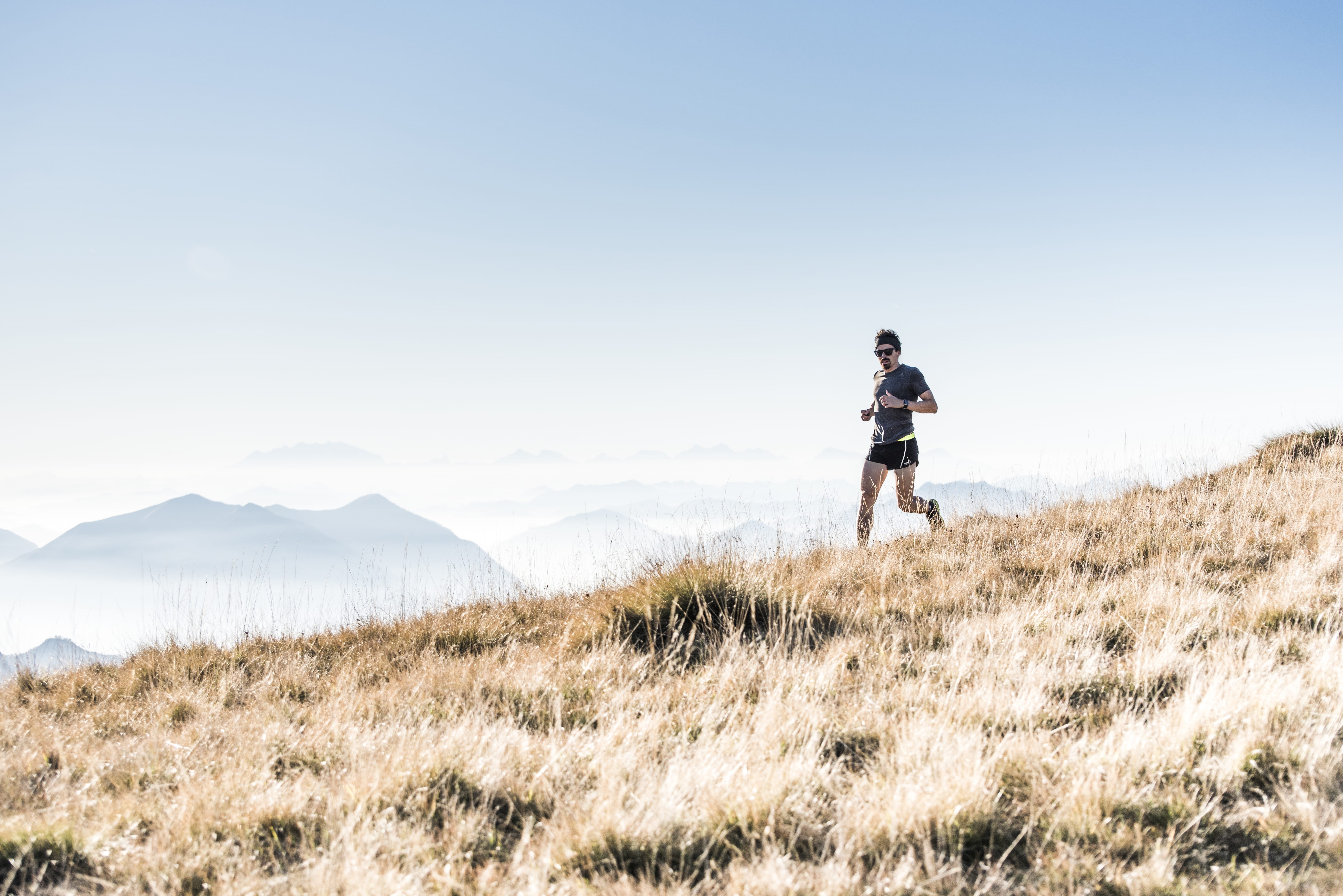 running, hill, grass, person, land, gradient, landscape, scenics - nature, daytime, 5K, leisure activity, adult, sunlight, mountain range, runner, sports, HD Wallpaper
