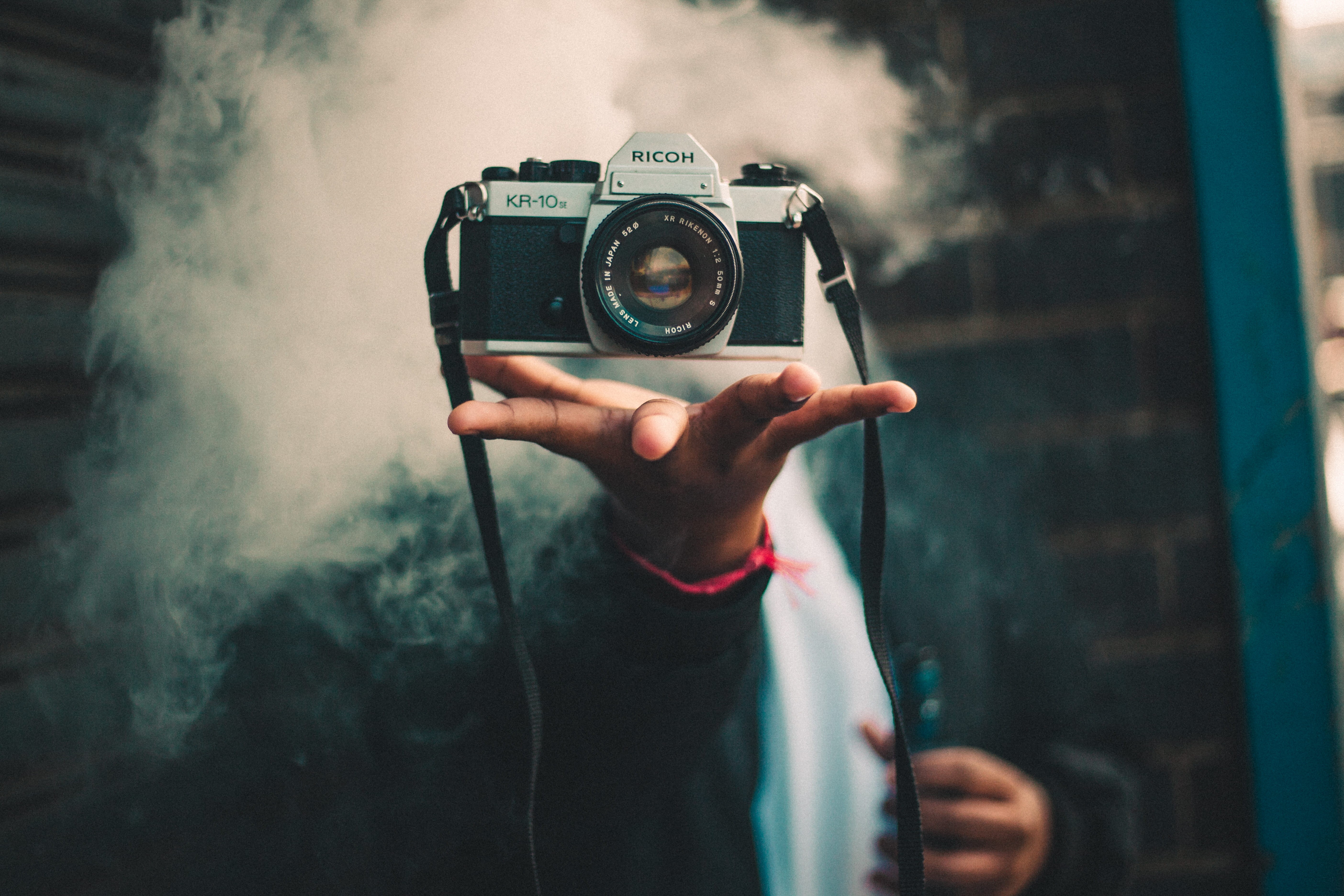slr camera, photographing, activity, 5K, lifestyles, levitation, hand, trick, equipment, vape, silver, dslr, adult, occupation, person, digital camera, HD Wallpaper