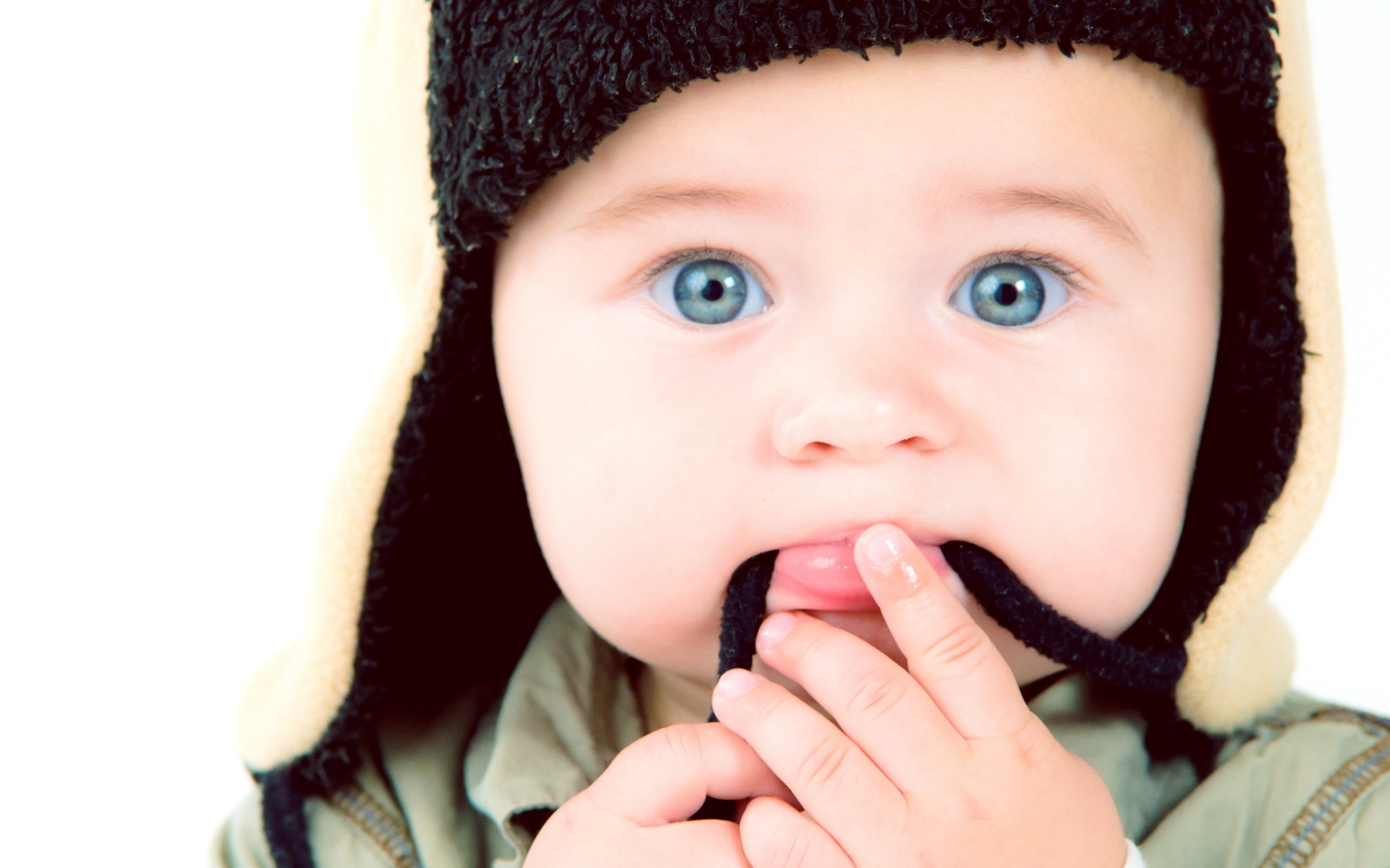 2K, face, studio shot, baby, front view, s, finger, mouth open, clothing, innocence, blue eyes, females, hat, body part, blue, headshot, human body part, HD Wallpaper