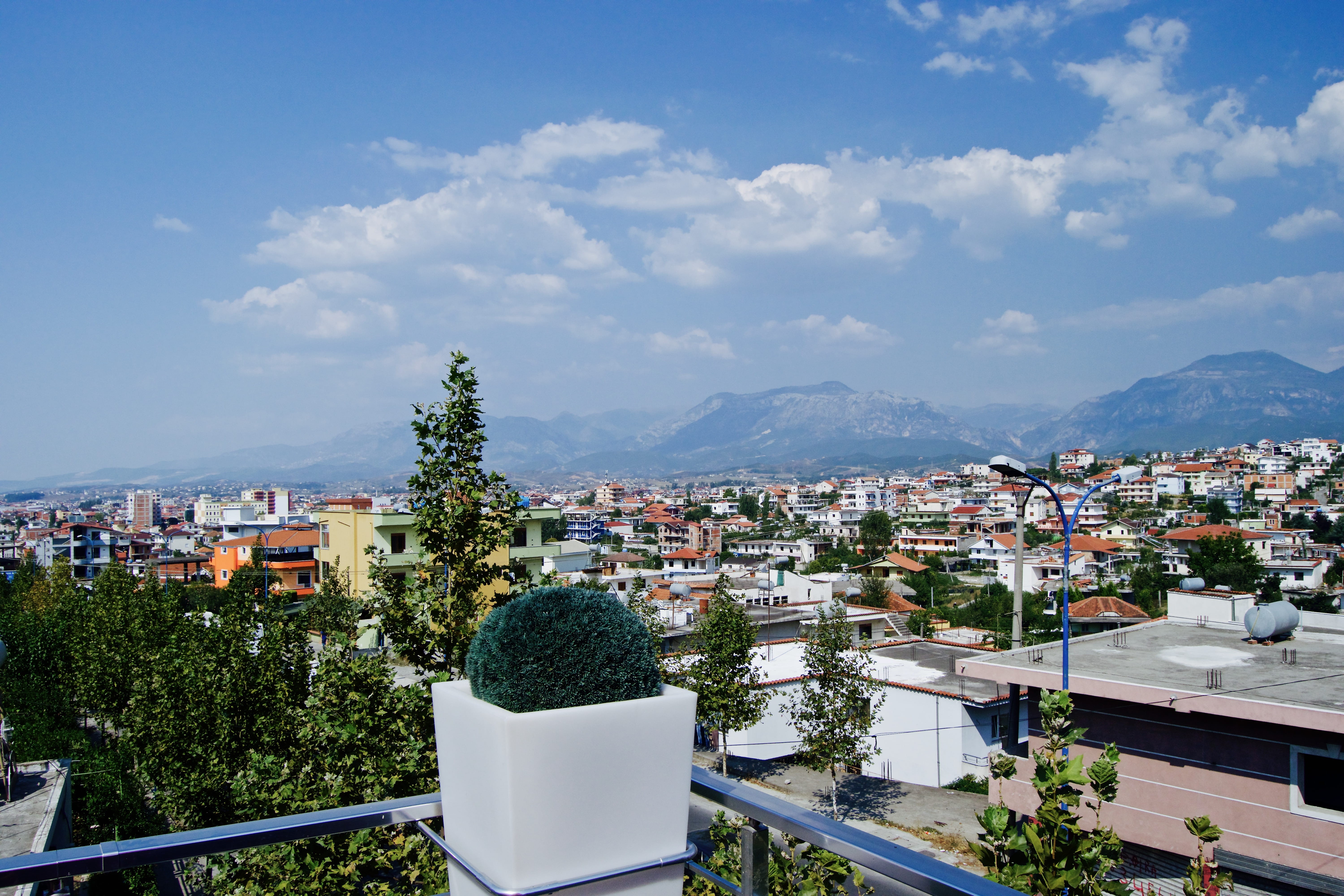 high angle view, 5K, cityscape, nature, built structure, tirana, cloud - sky, balcony, city, day, townscape, mountains, architecture, sky, house, plant, HD Wallpaper