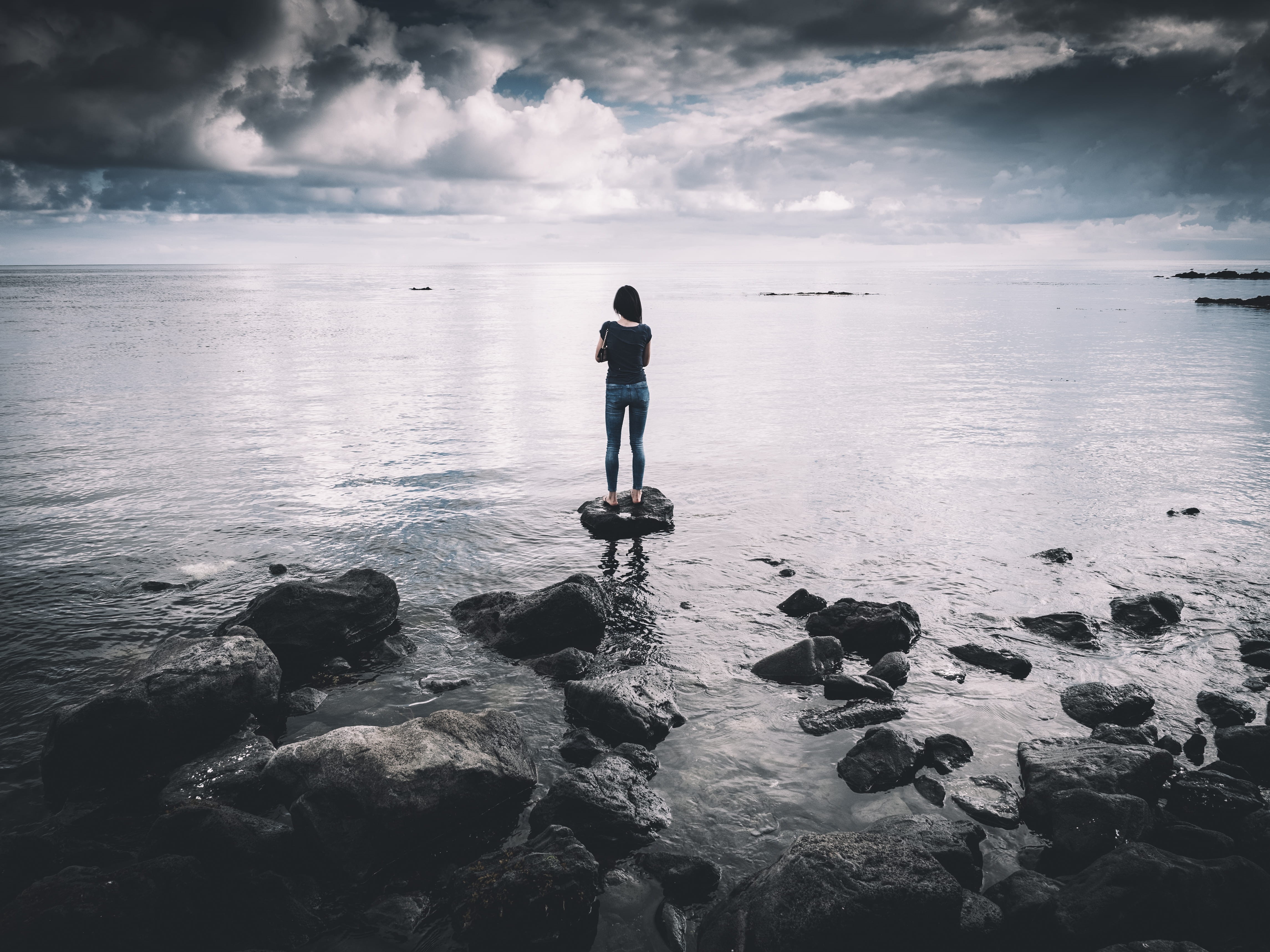 beauty in nature, color Image, one woman only, nature, standing, gray, loneliness, cloud - sky, woman, t-shirt, black, one Person, sea, real people, beach, HD Wallpaper