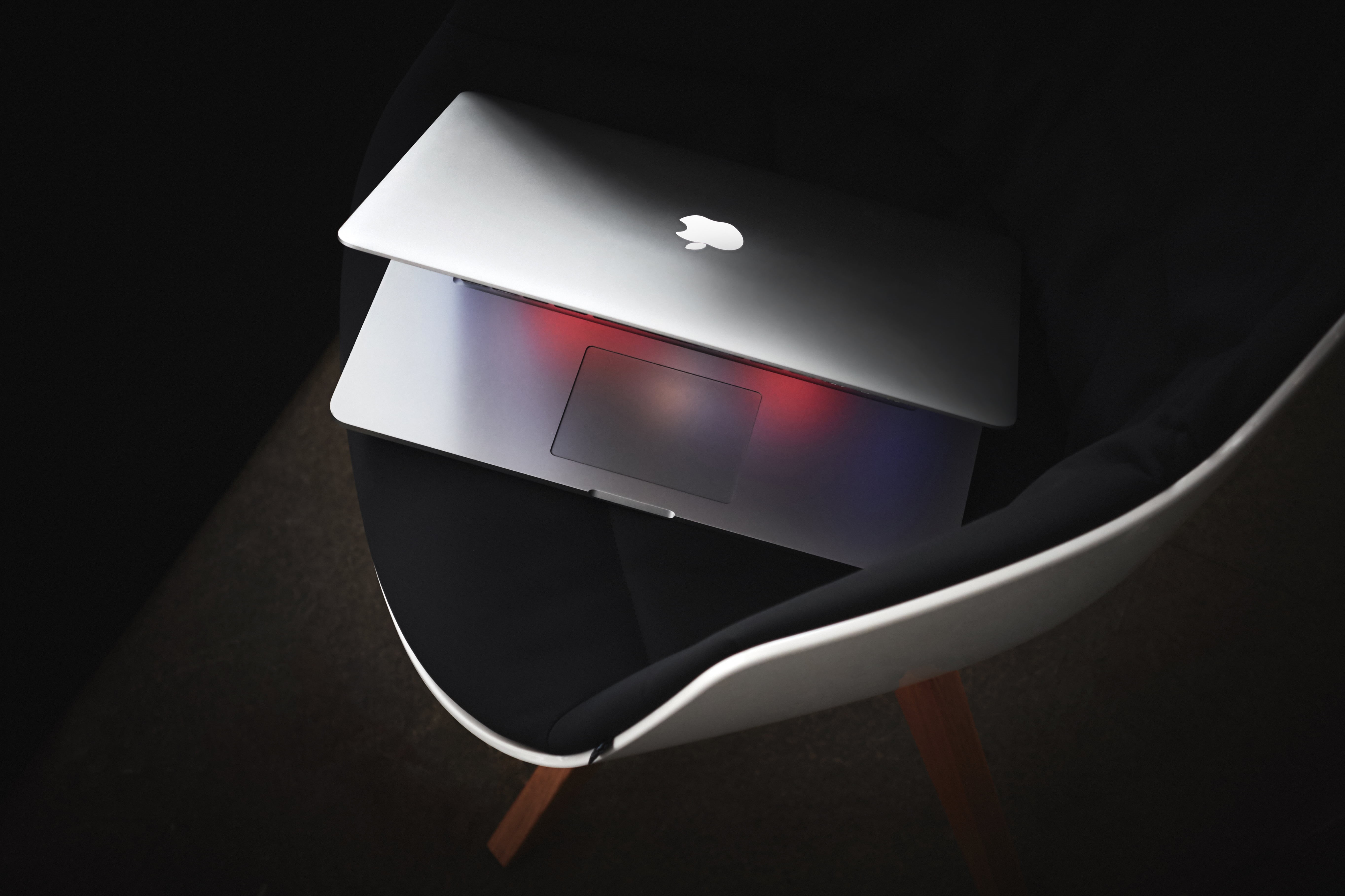 communication, black background, indoors, 5K, technology, chair, high angle view, illuminated, modern, reflection, furniture, mac book, night, logo, single object, HD Wallpaper