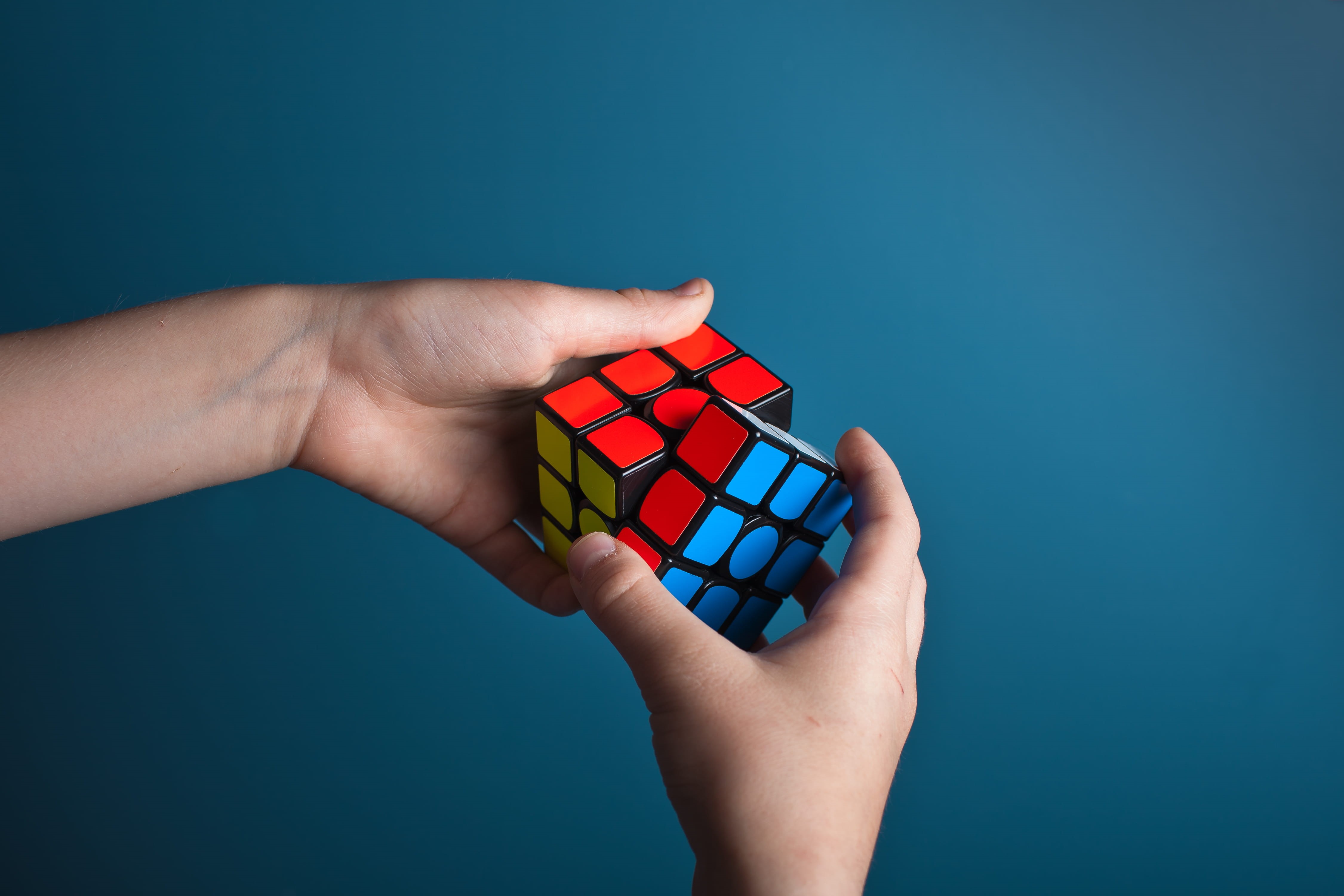 rubiks cube, blue, challange, business, close-up, cut out, red rubik, puzzle, human hand, body part, red, hands, copy space, finger, magic, hand, smart, HD Wallpaper