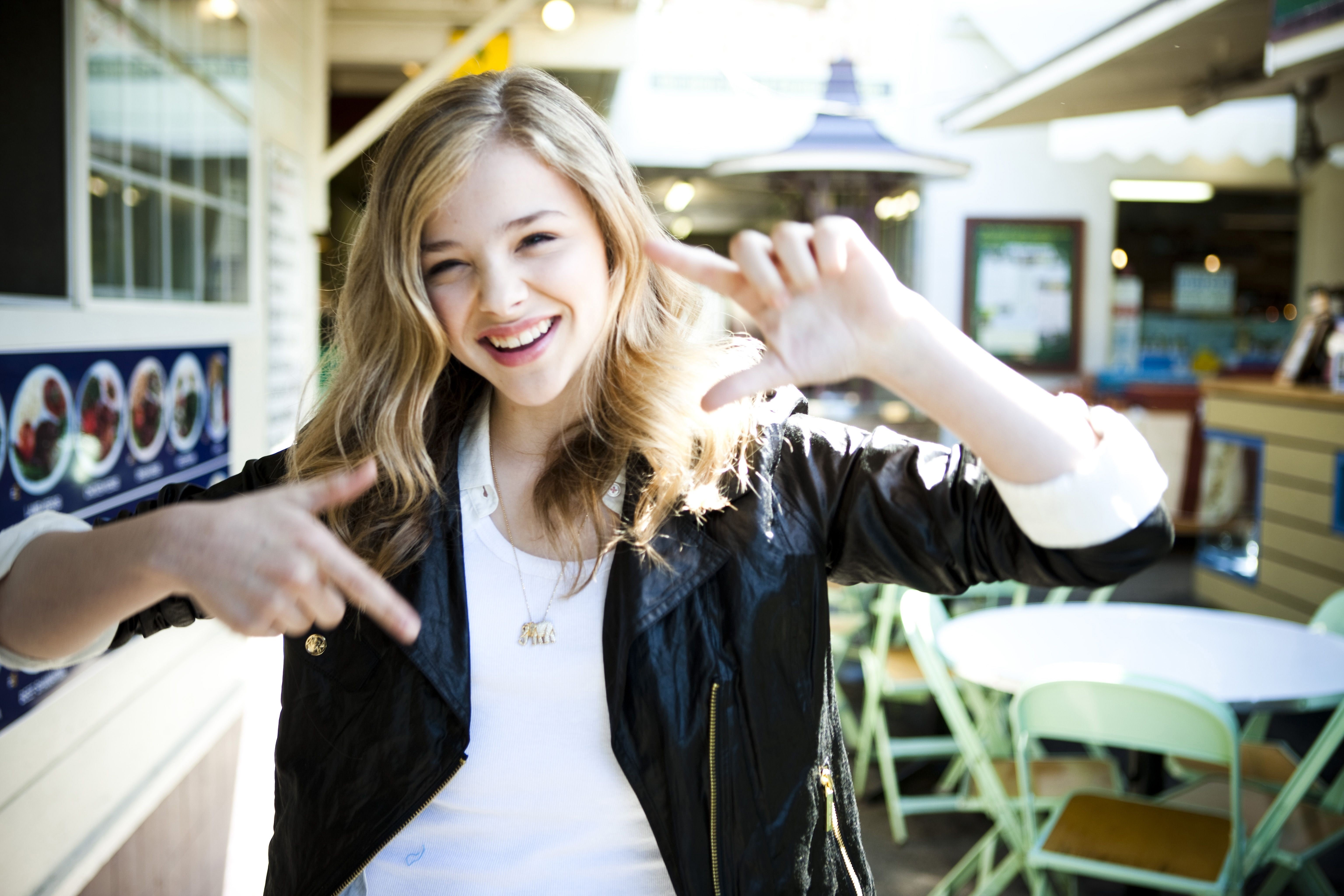 Chloë Grace Moretz, blond hair, grace, indoors, toothy smile, happiness, real people, teeth, lifestyles, front view, standing, smiling, one person, hairstyle, HD Wallpaper