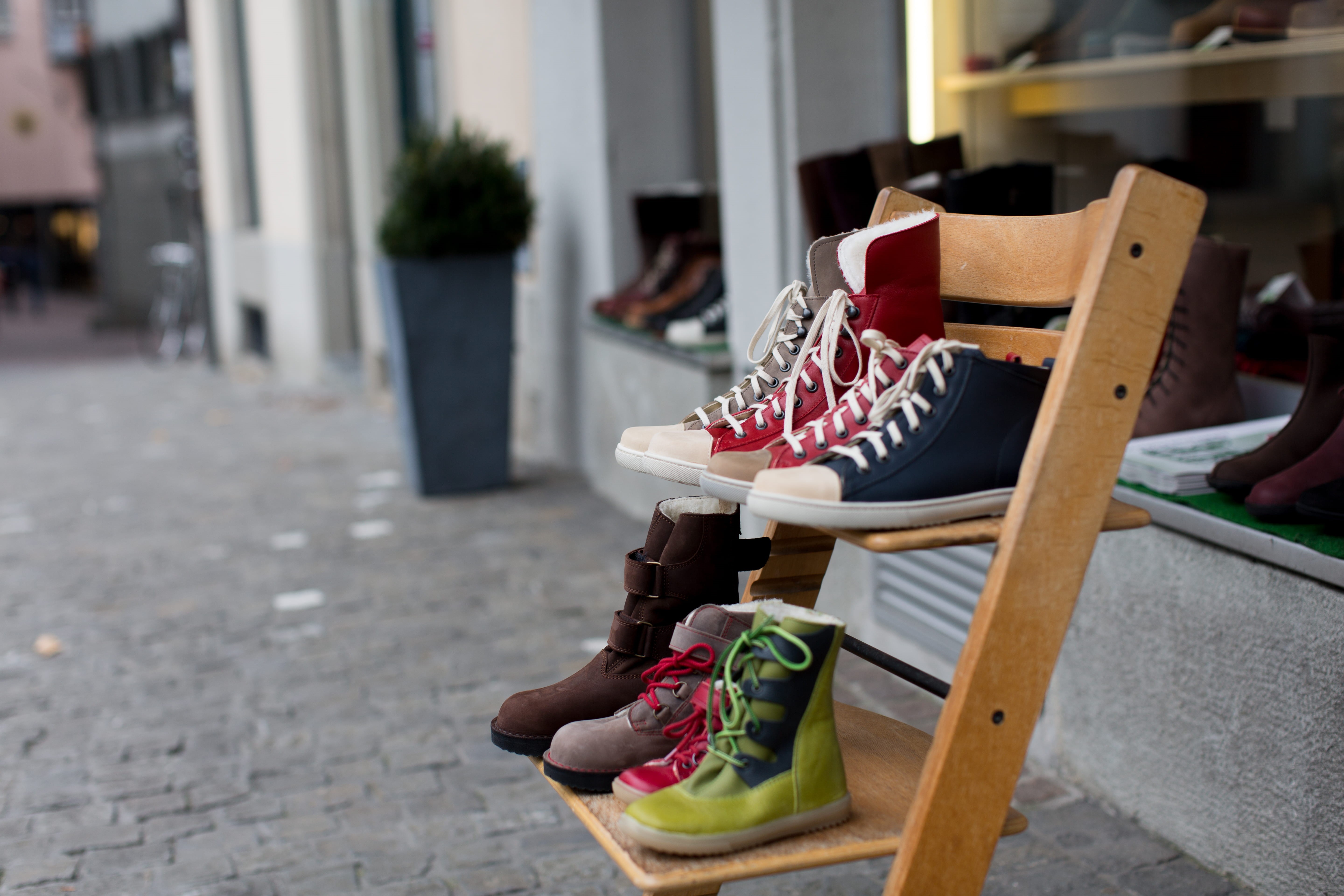focus on foreground, shelf, assorted, store, low section, shoes, clothing, shoe, incidental people, wooden, shop, street, boots, brands, day, unpaired, HD Wallpaper