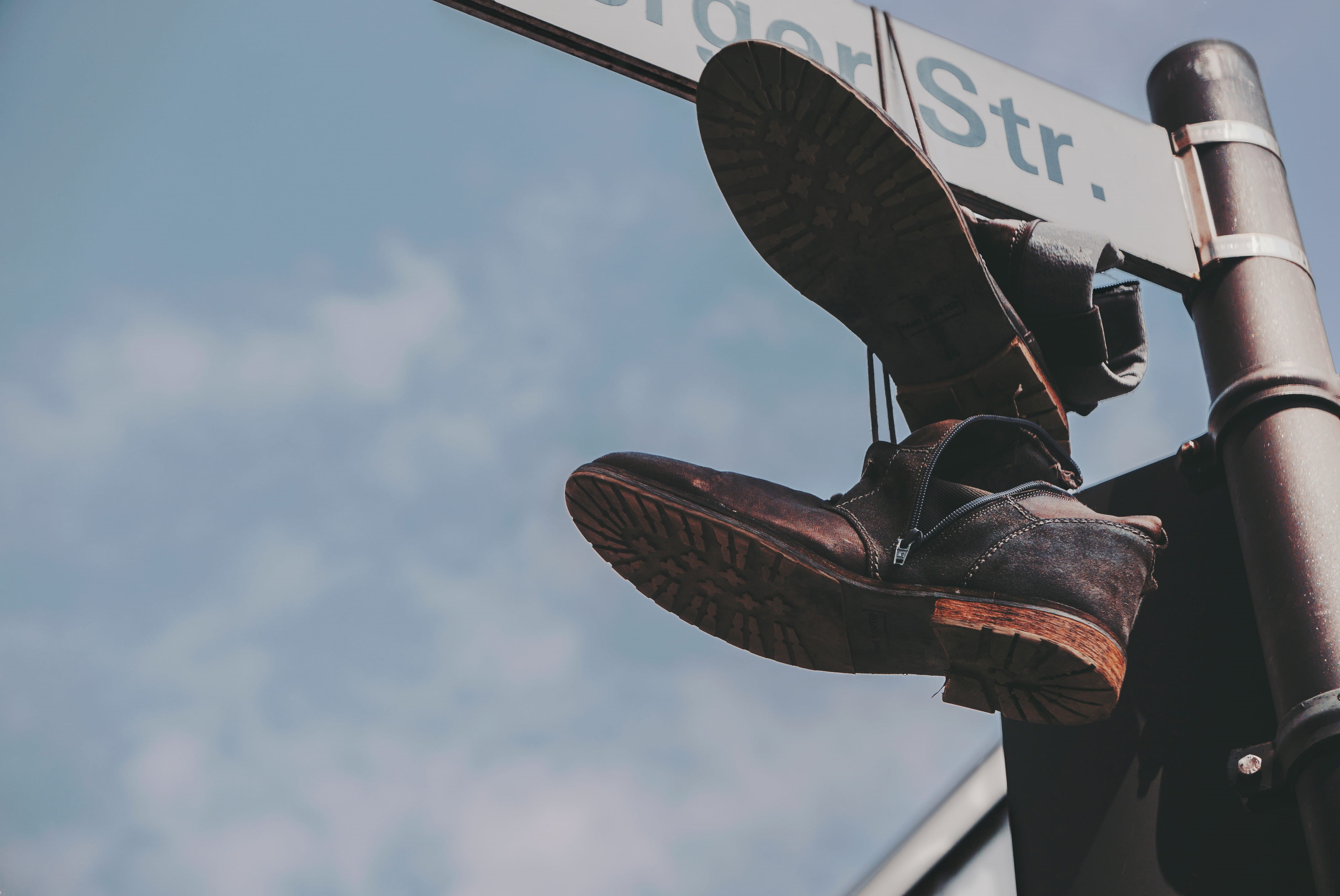 focus on foreground, sign, signage, outdoors, protection, nature, shoes, dangling, boots, mode of transportation, travel, hanging, boot, communication, HD Wallpaper