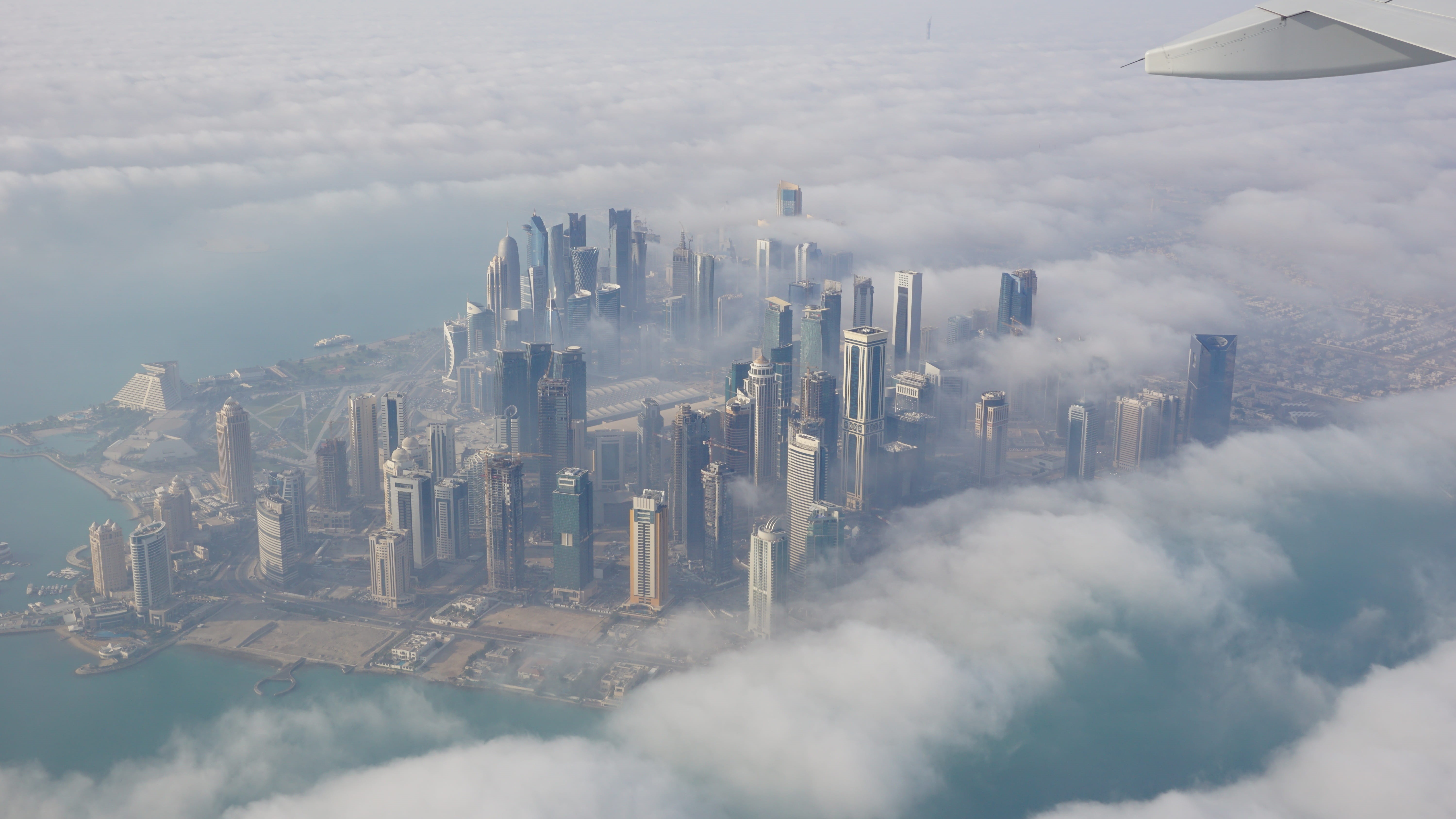 travel, cityscape, daylight, architecture, building Exterior, clouds, city, built Structure, no people, air pollution, business, tower, doha, day, aerial View, HD Wallpaper