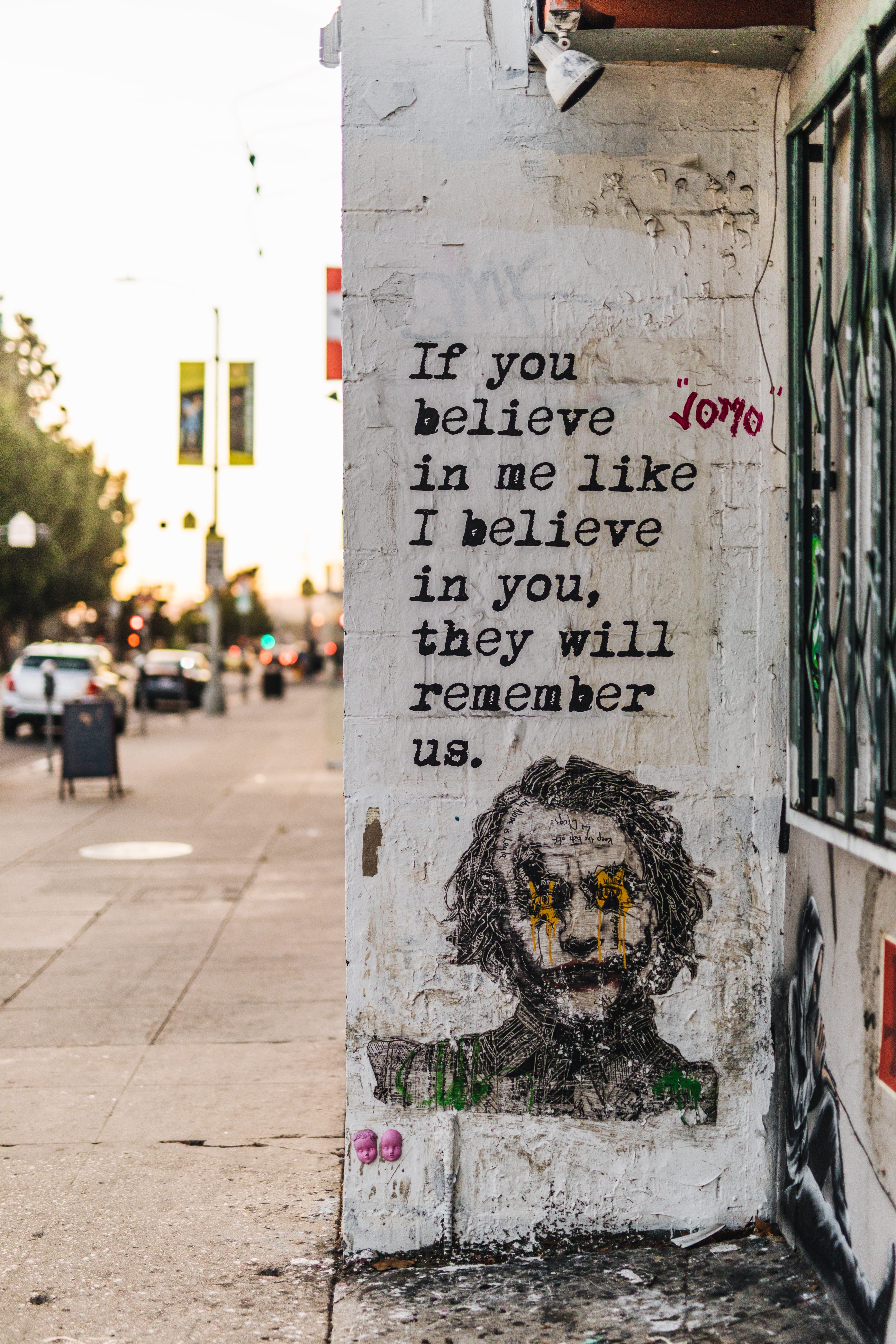 text, sign, portrait, joker, no people, script, wall, representation, focus on foreground, street, built structure, print, western script, communication, Phone HD Wallpaper