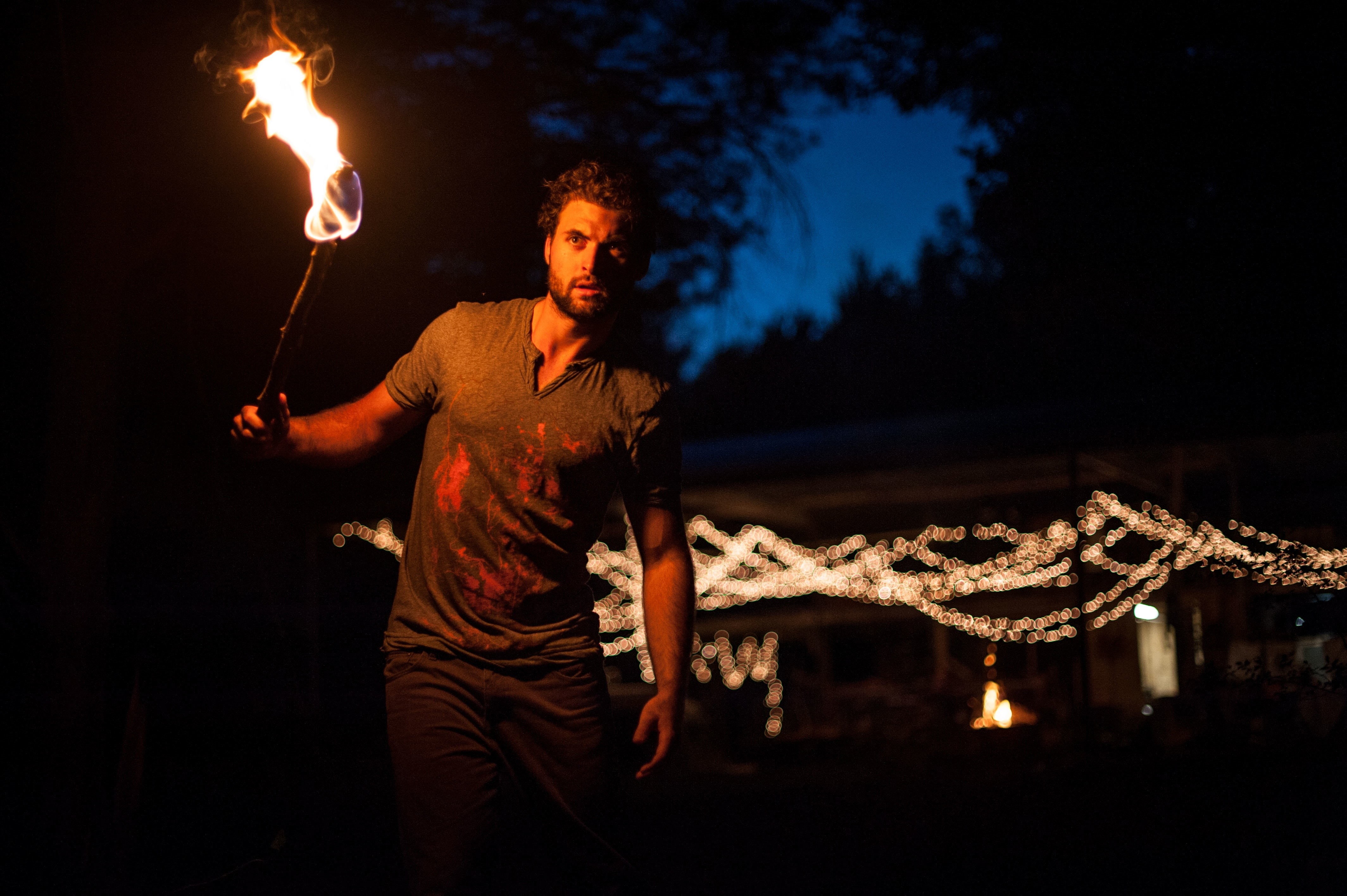 standing, fire - natural phenomenon, performance, illuminated, sign, three quarter length, light, dark, bokeh, warning sign, nightlife, sparkler, torch, HD Wallpaper