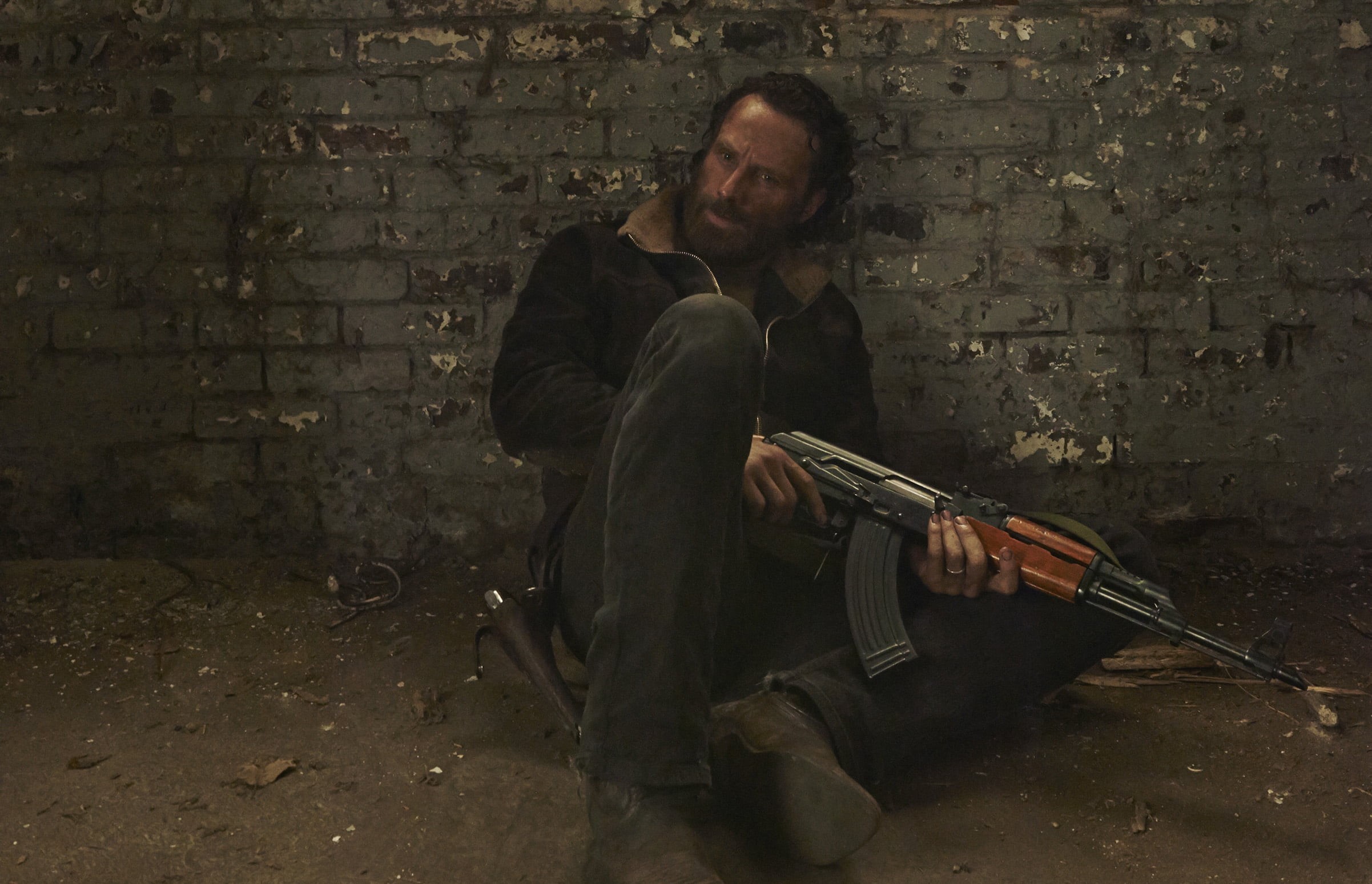 lifestyles, men, adult, contemplation, brick wall, 1080P, Andrew Lincoln, clothing, brick, real people, holding, front view, wall, young men, young adult, HD Wallpaper