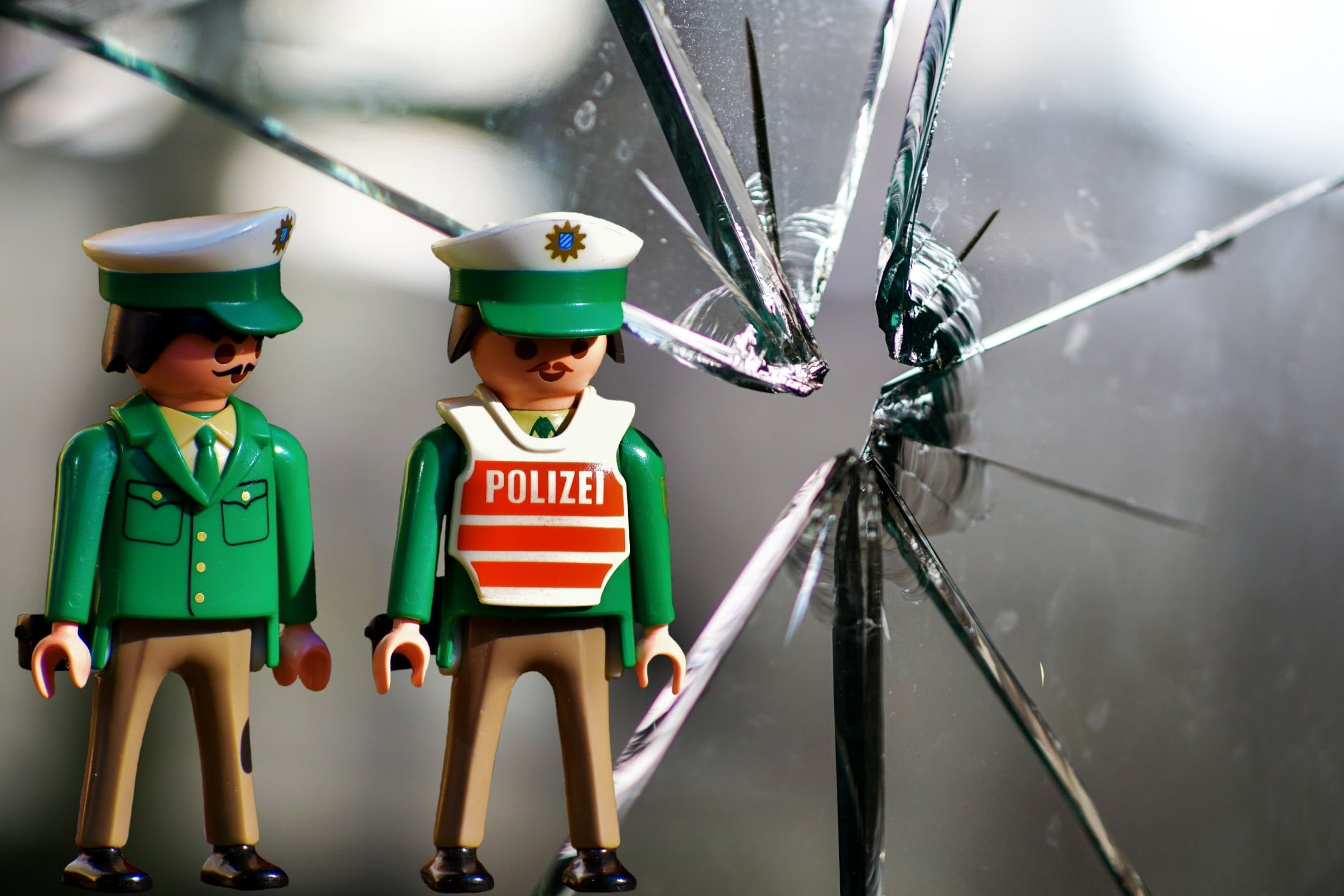 males, green, togetherness, funny, fragmented, figures, casual clothing, people, bullet hole, broken, jumped, damage, two people, police officers, glass breakage, HD Wallpaper