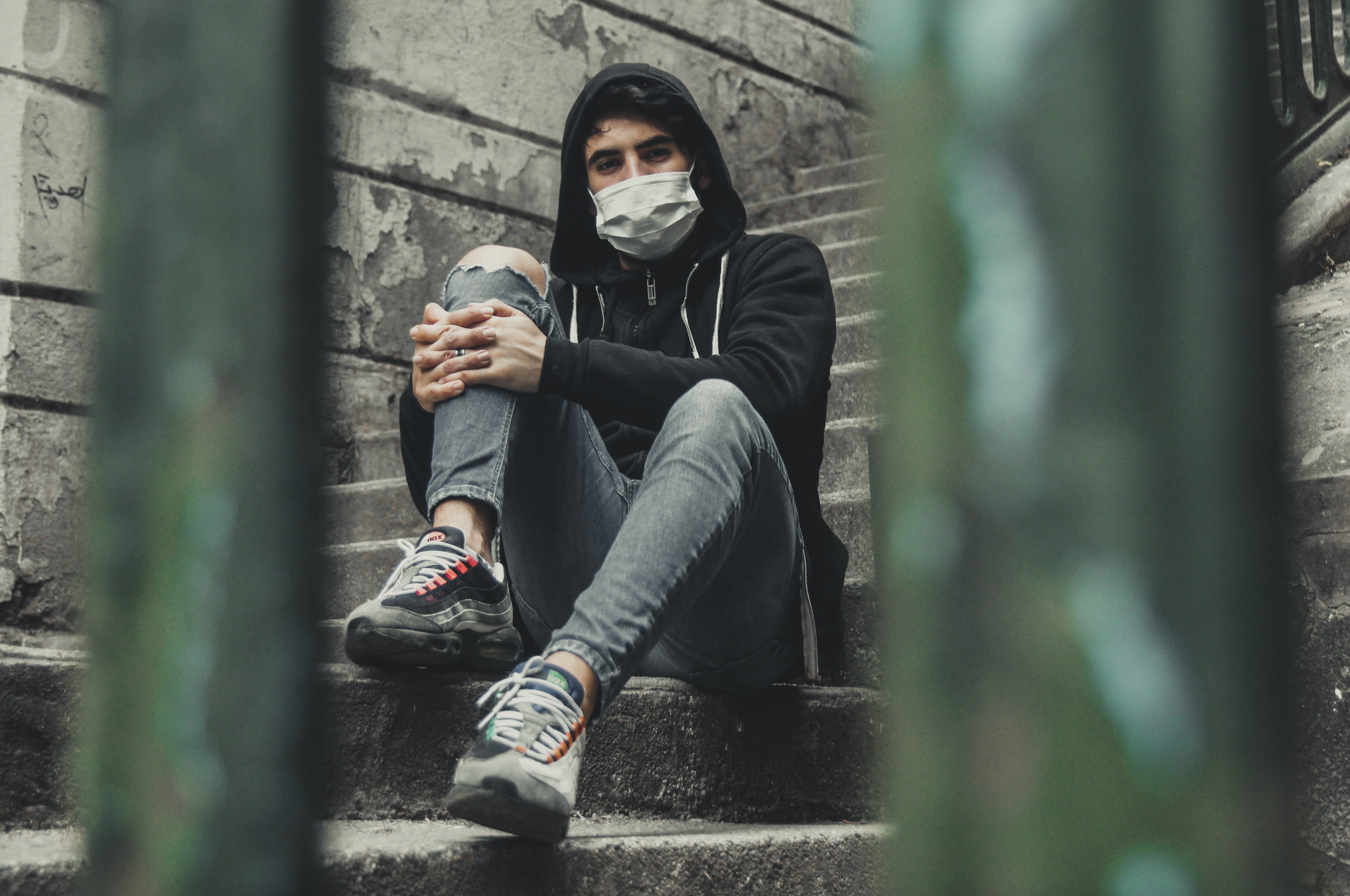 male, leisure activity, sitting, footwear, 4K, man, urban, sneaker, real people, purge, person, full length, selective focus, outdoors, clothing, pose, HD Wallpaper