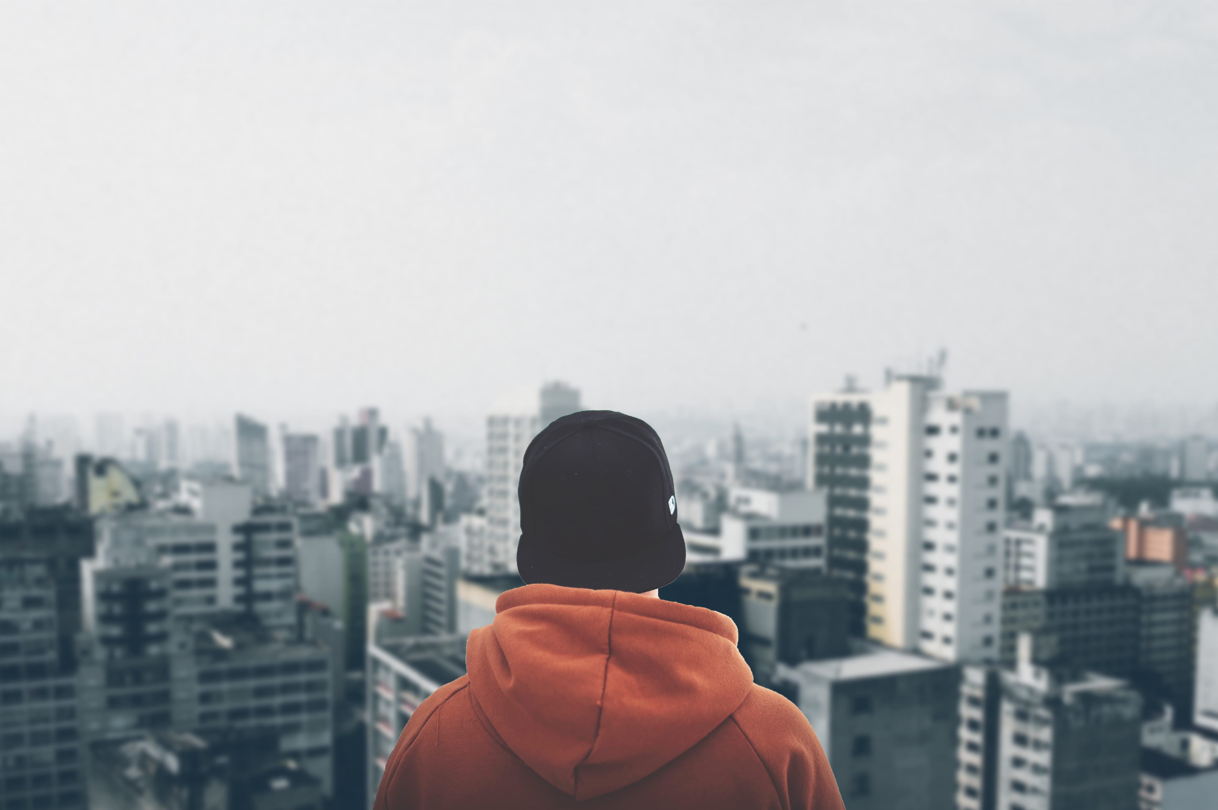 cityscape, hood - clothing, alone, day, buildings, skyscraper, contemplation, urban, landscape, clothing, headshot, rear view, men, outdoors, business, HD Wallpaper