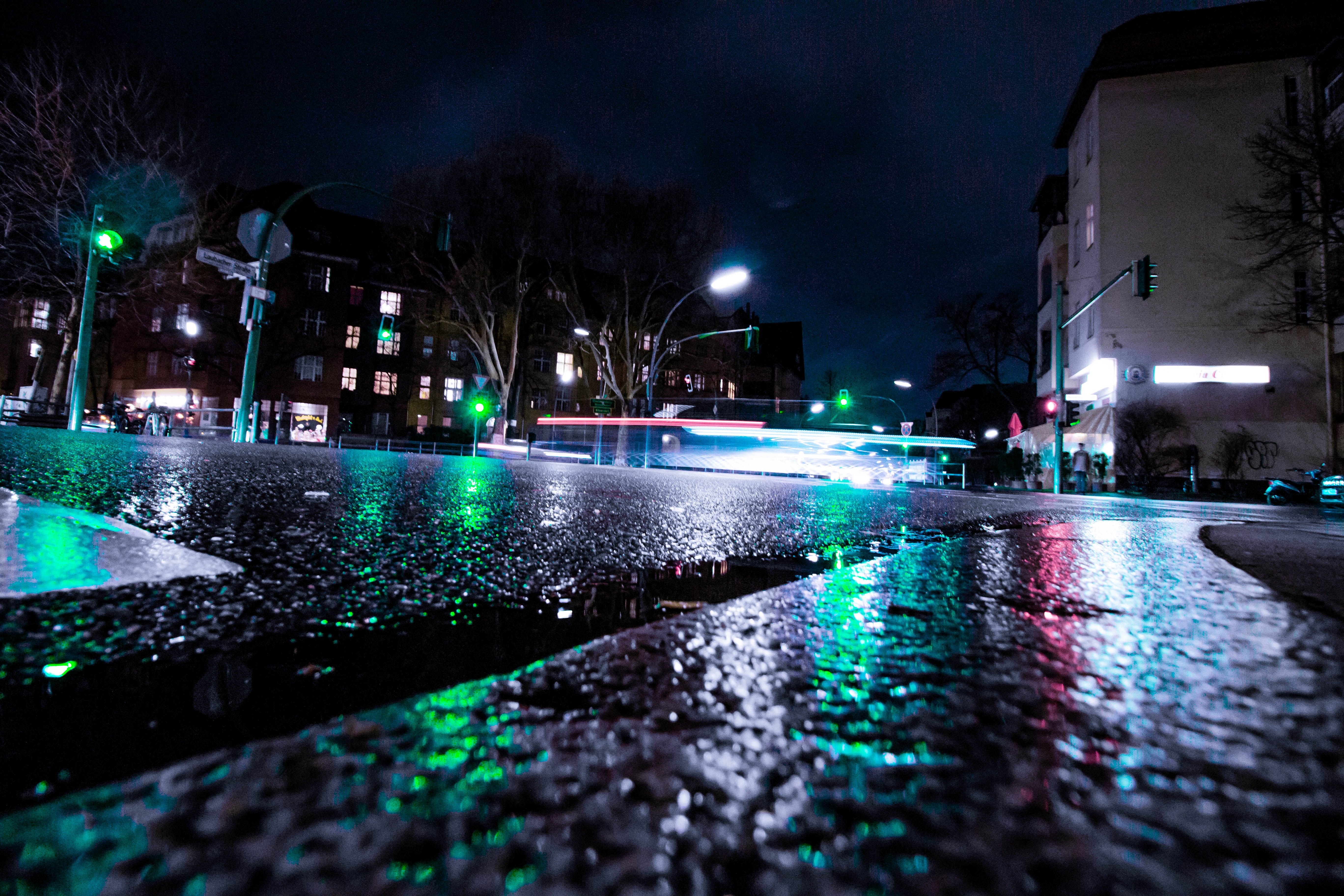 automobile, car, illuminated, nature, traffic light, street light, asphalt, water, surface level, tarmac, light, nightlife, town, flare, rain, 5K, human, HD Wallpaper