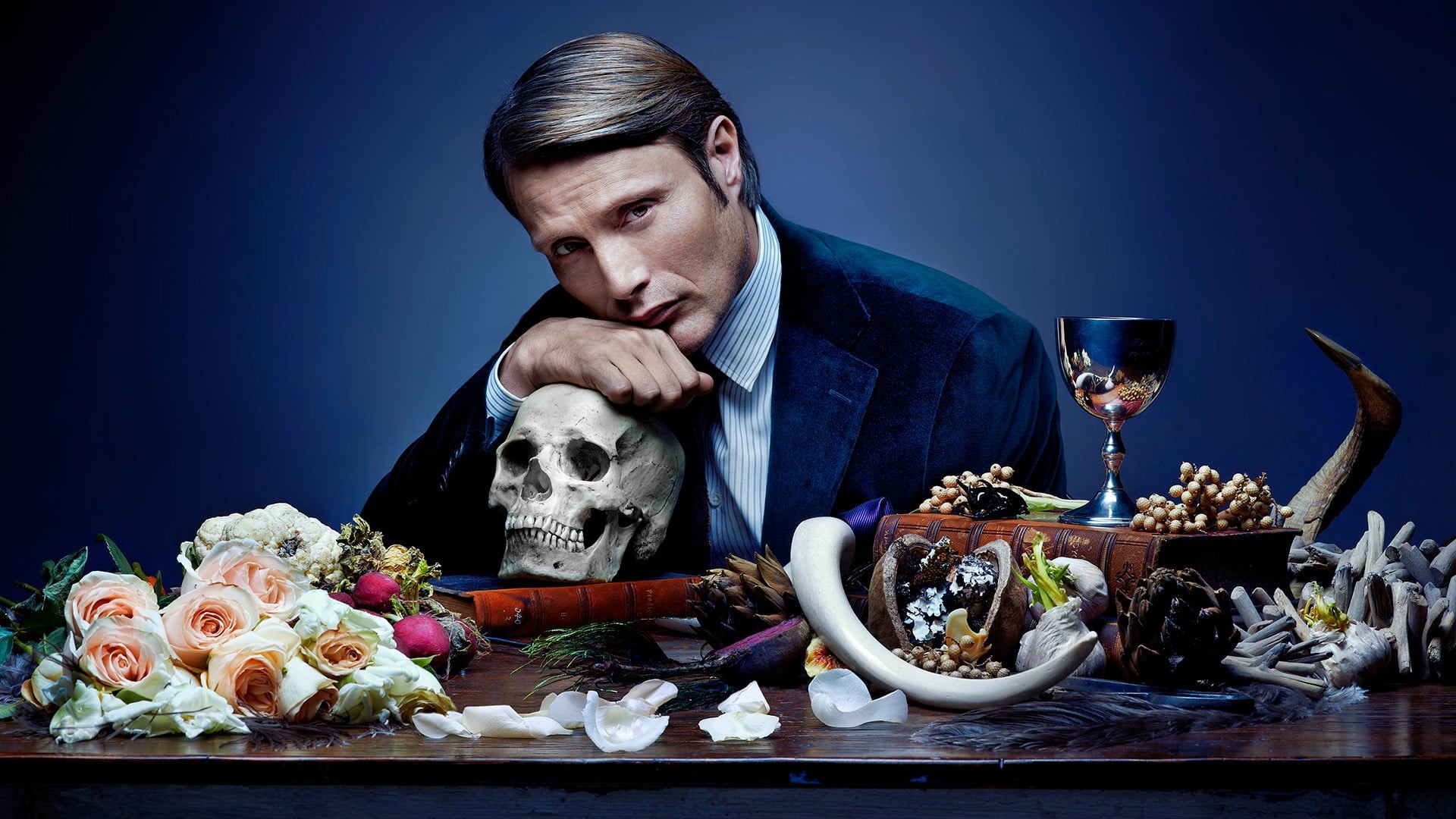 one person, freshness, food and drink, vegetable, table, waist up, Hannibal, flower, Mads Mikkelsen, blue, flowering plant, glass, business, sitting, mads, HD Wallpaper