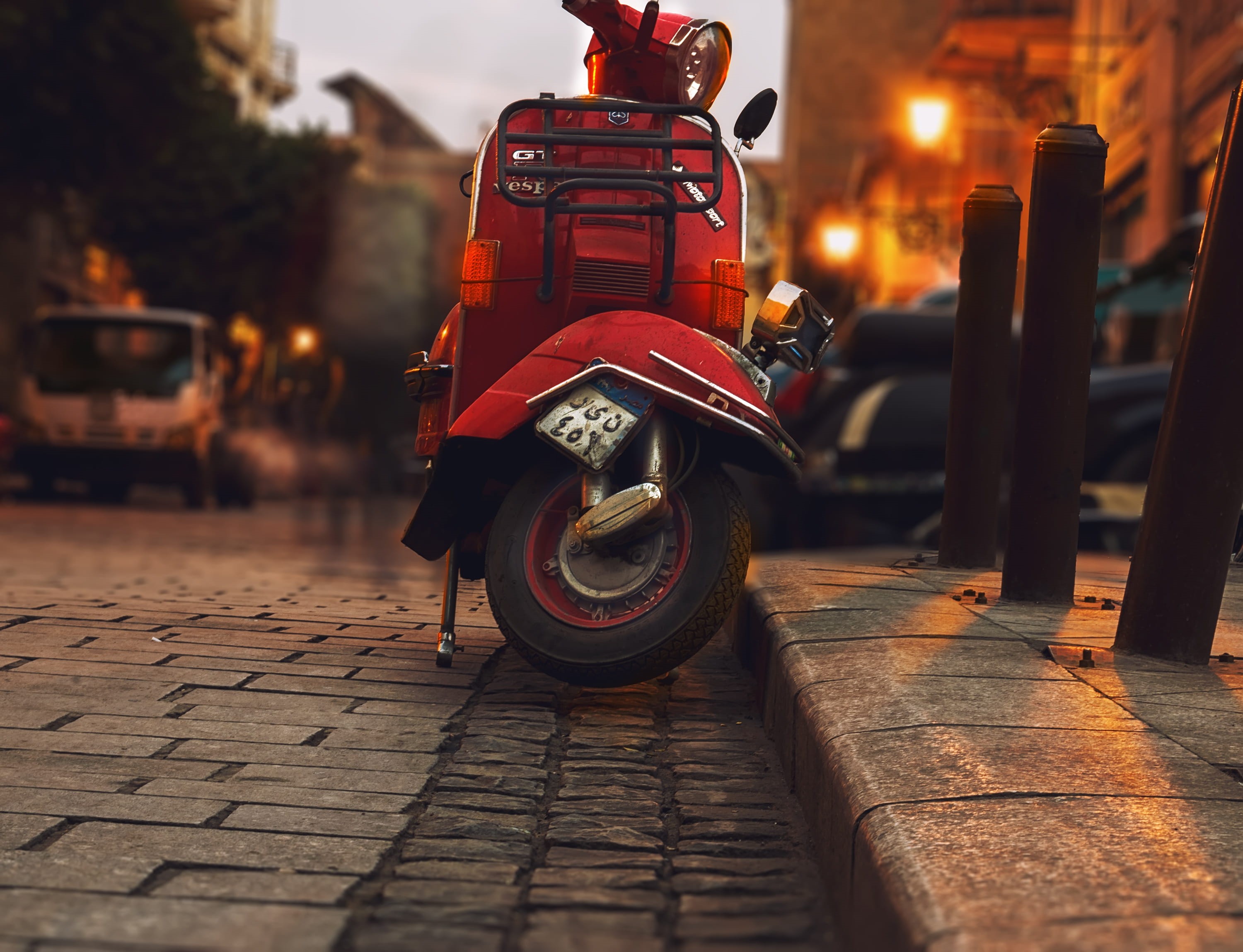 stationary, cobblestone, vehicle, road, vehicles, building exterior, blur, night, scooter, motor, sidewalk, motor vehicle, city, mode of transportation, HD Wallpaper