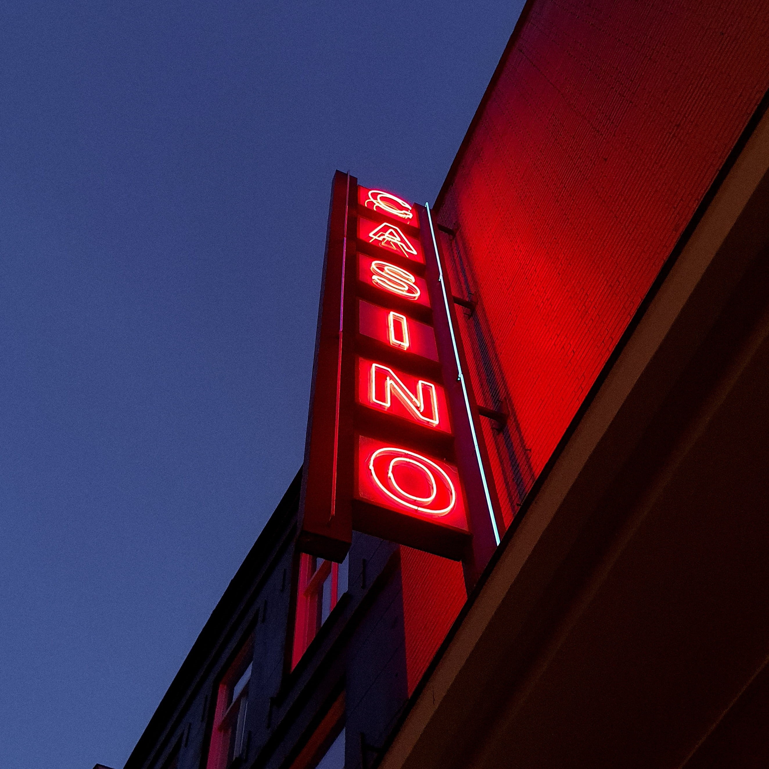 sign, city, building, sky, building exterior, red, hotel, redlight, sunset, casino, information, minimalist, corner, 2K, clear sky, trademark, illuminated, Phone HD Wallpaper