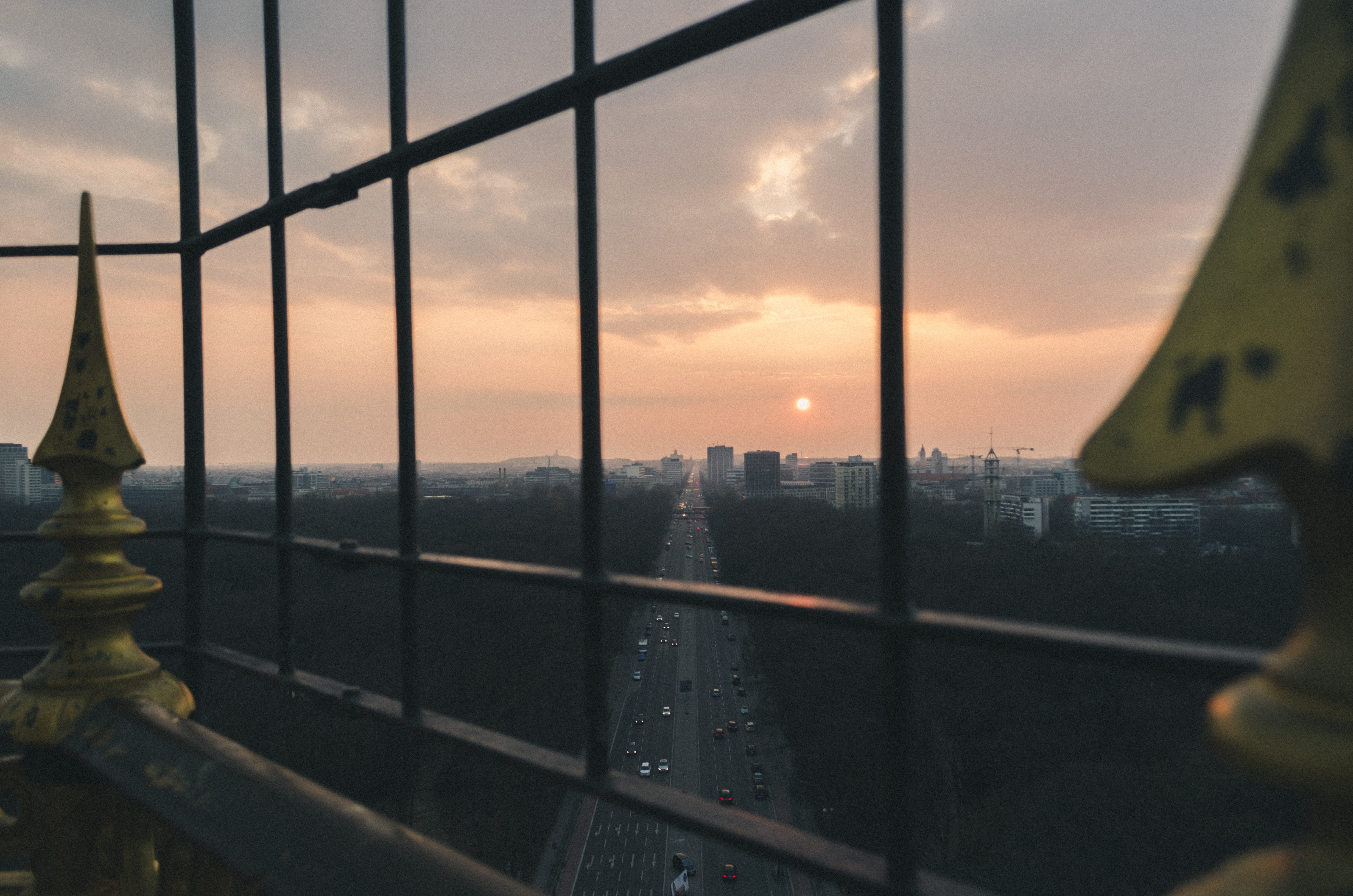 office building, outdoors, sunset, sky, light, cityscape, human, metal, glass, window, showing, person, road, banister, railing, spire, clear, built structure, HD Wallpaper