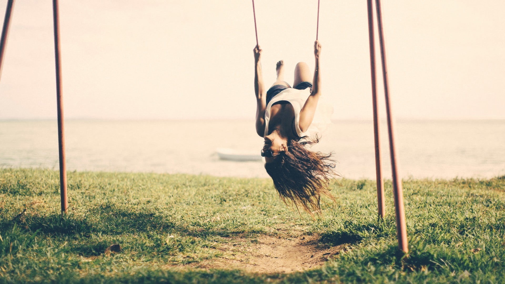 leisure activity, day, grass, sea, sport, outdoors, plant, sunlight, nature, swings, sky, women outdoors, upside down, 1080P, brunette, full length, one person, HD Wallpaper
