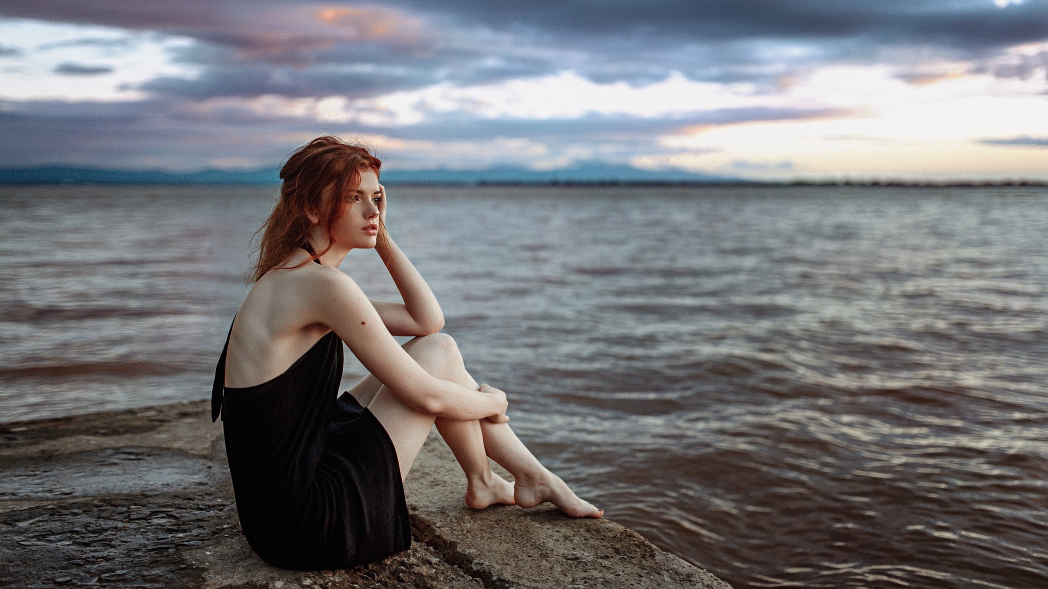 pale, leisure activity, water, cloud - sky, sunset, sleeveless, beach, feet, sitting, one person, black dress, hair, full length, redhead, young women, HD Wallpaper