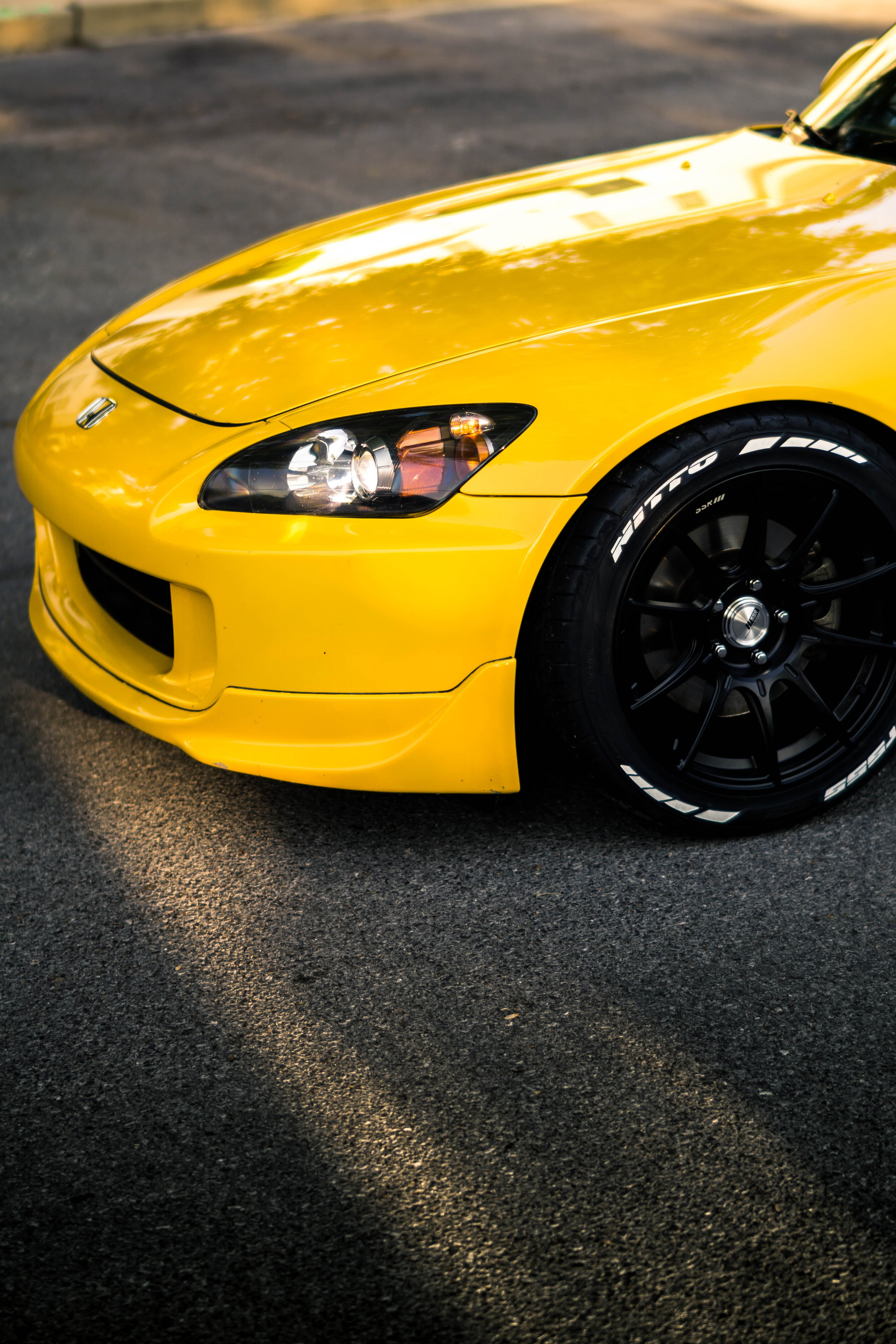 s2k, close-up, black, motor vehicle, no people, headlight, nitto, yellow taxi, day, s2000, stationary, land vehicle, sports car, 5K, rim, personal land vehicle, Phone HD Wallpaper