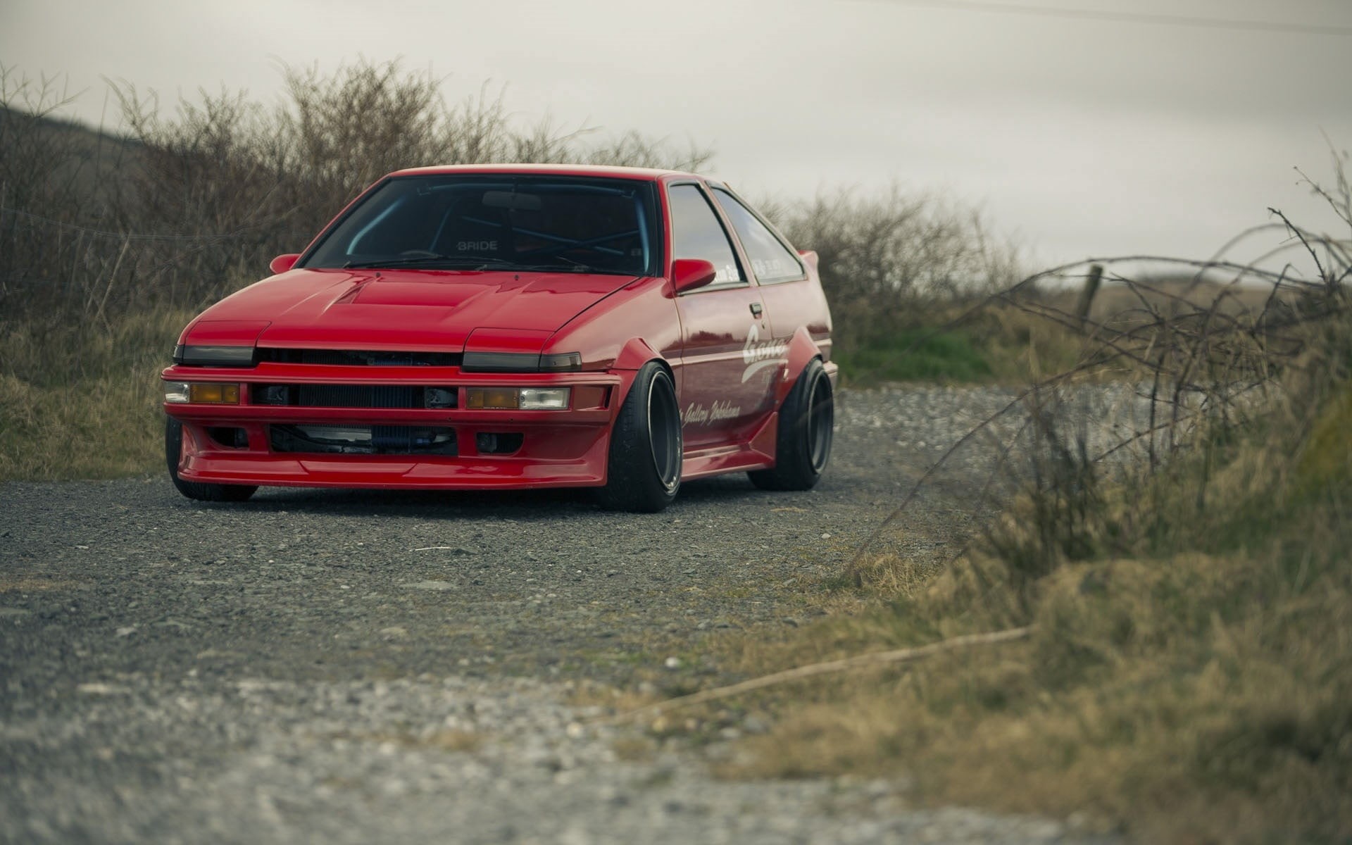 grass, AE86, street, sky, Red, land vehicle, selective focus, road, plant, sports, car, city, day, outdoors, transportation, land, field, travel, Toyota, HD Wallpaper
