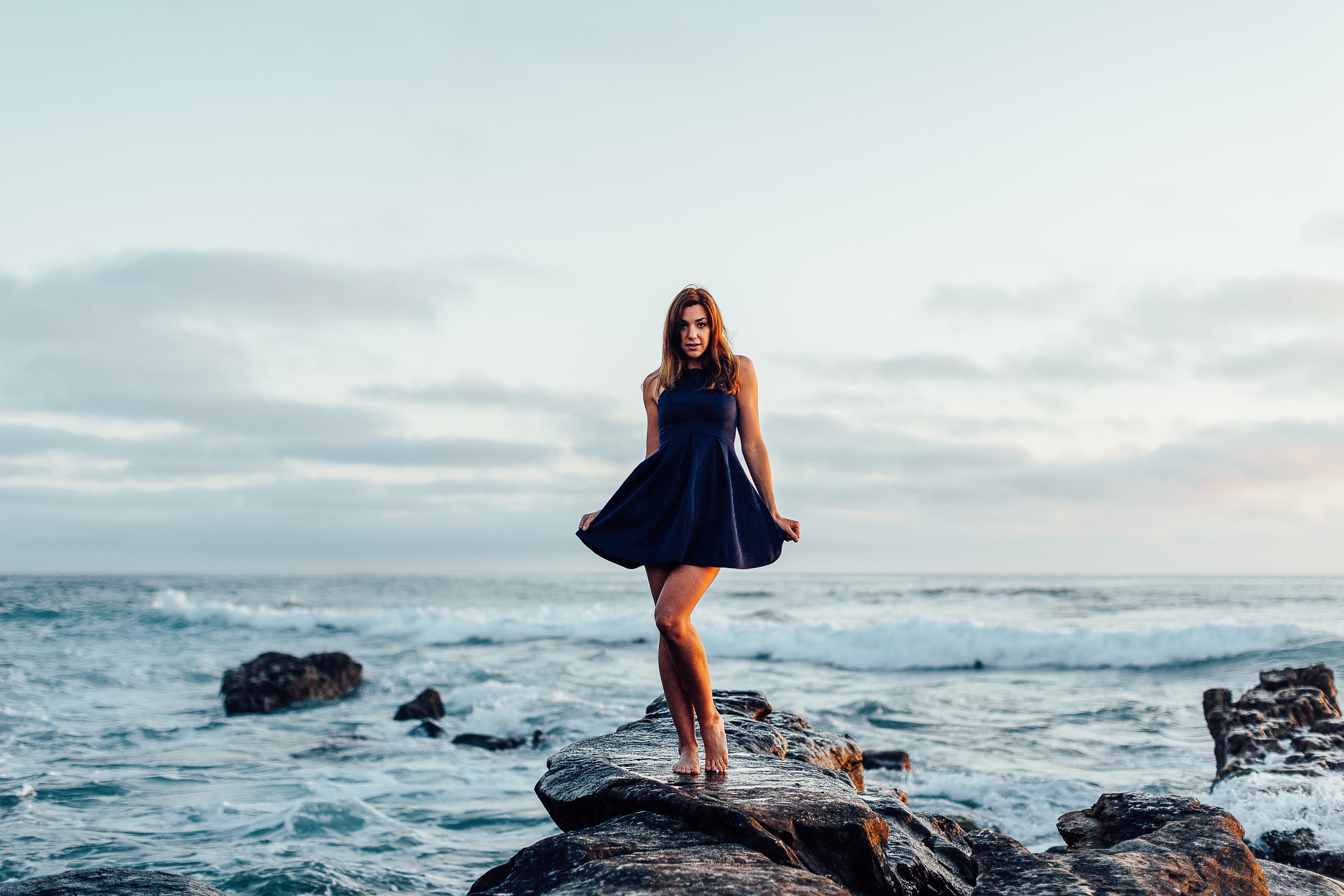 dress shirt, rock - Object, people, outdoors, sea, horizon over water, daytime, freedom, full length, relaxation, women, woman, young women, woman in black, HD Wallpaper