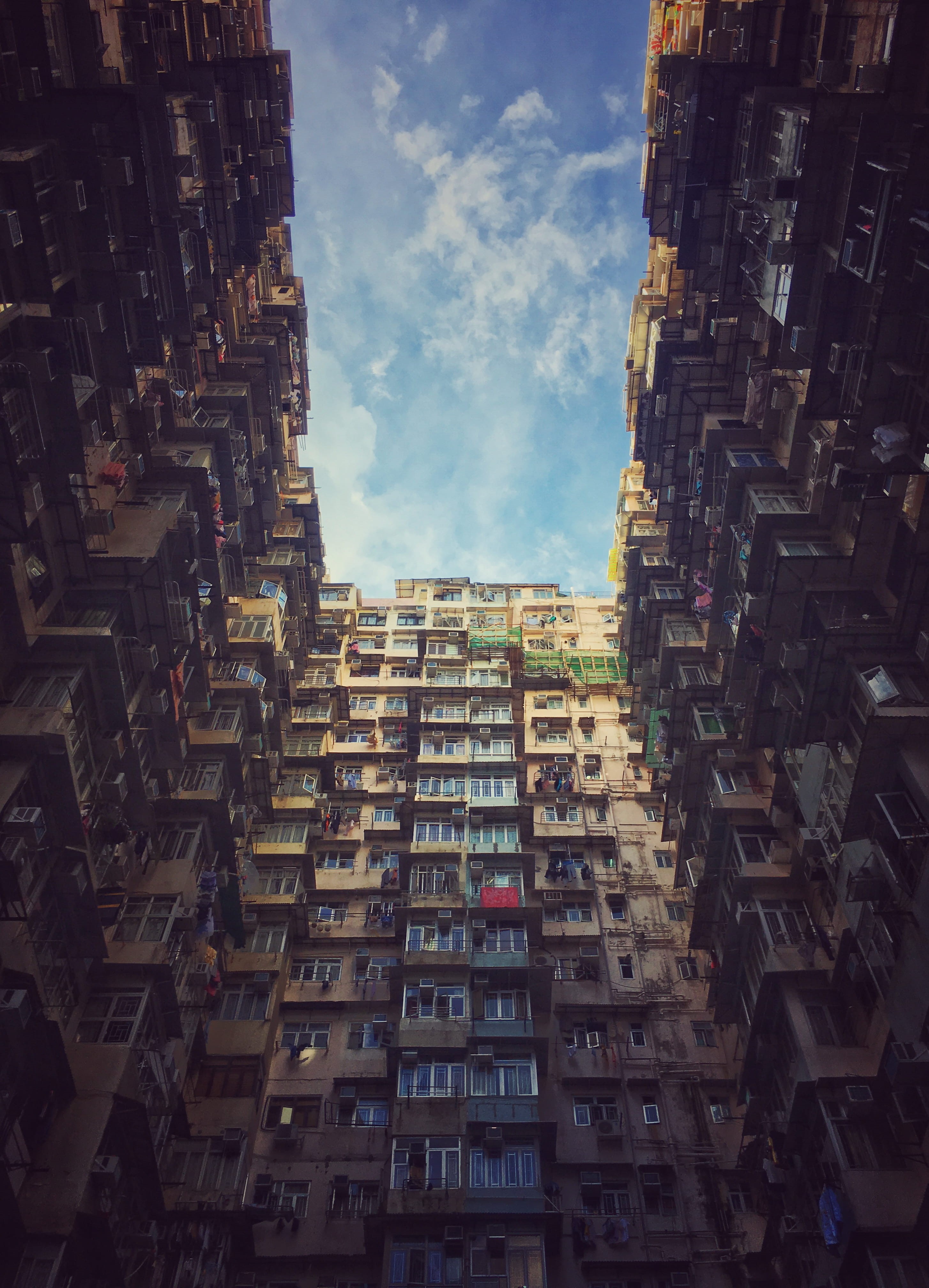 building exterior, house, residential district, low angle view, no people, cityscape, window, cloud - sky, city, day, built structure, 4K, tall - high, Phone HD Wallpaper
