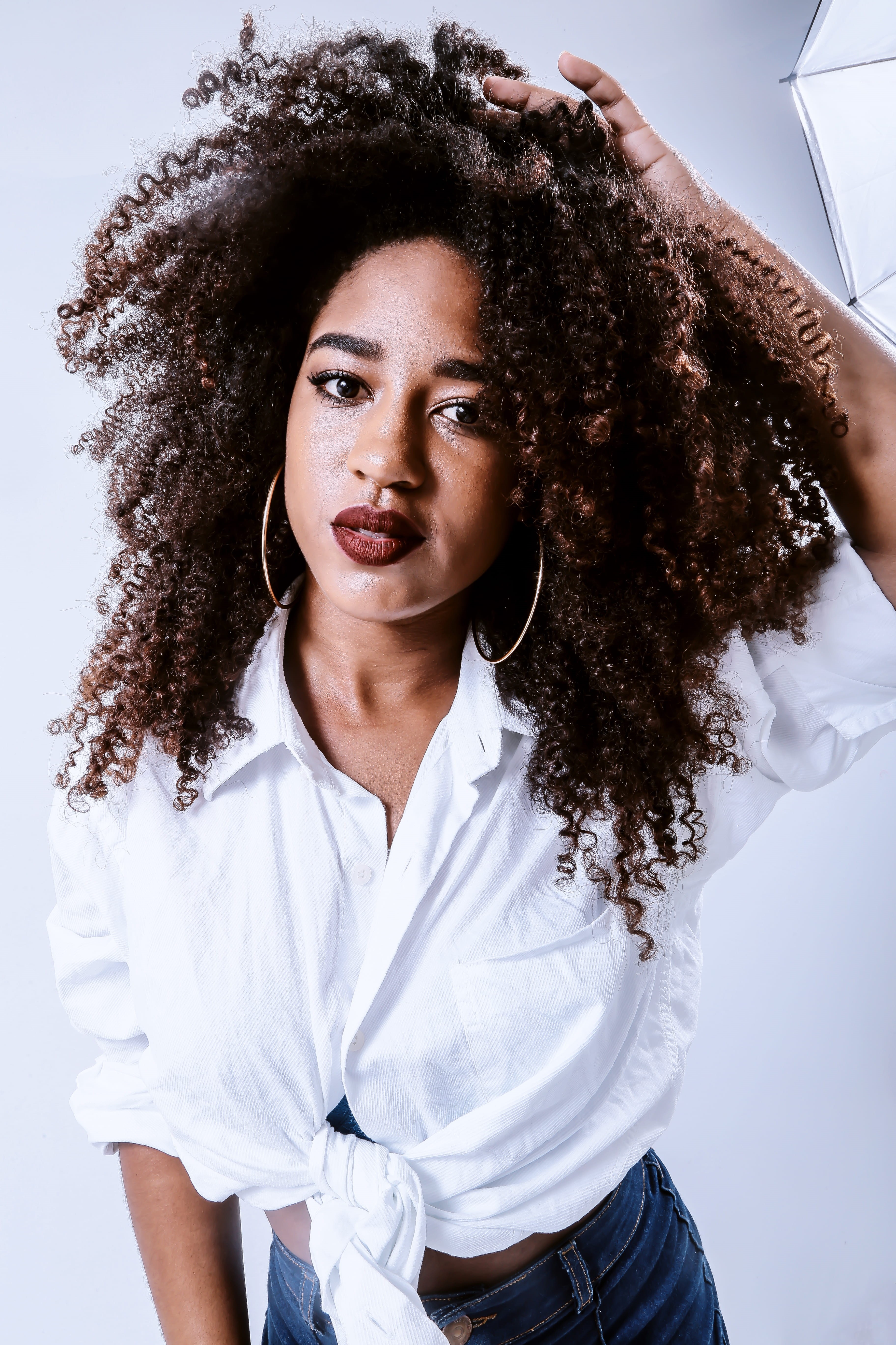 loop earrings, dark lipstick, female, african american, front view, portrait, left, photo, hairstyle, real people, leisure activity, raising, hand in hair, Phone HD Wallpaper
