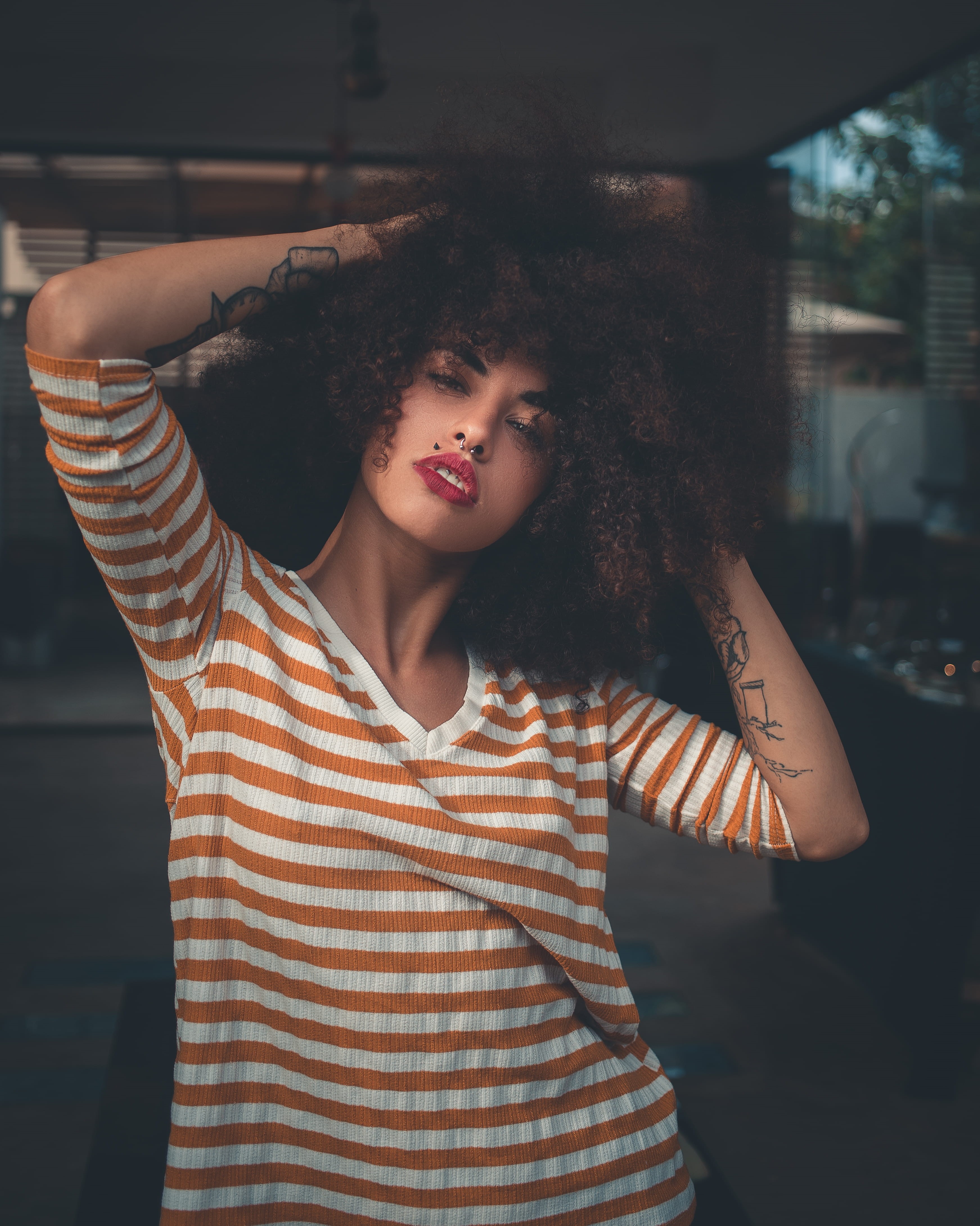 person, orange, front view, human arm, frizzy, curly hair, lifestyles, arms raised, real people, wear, indoors, focus on foreground, white, looking at camera, Phone HD Wallpaper
