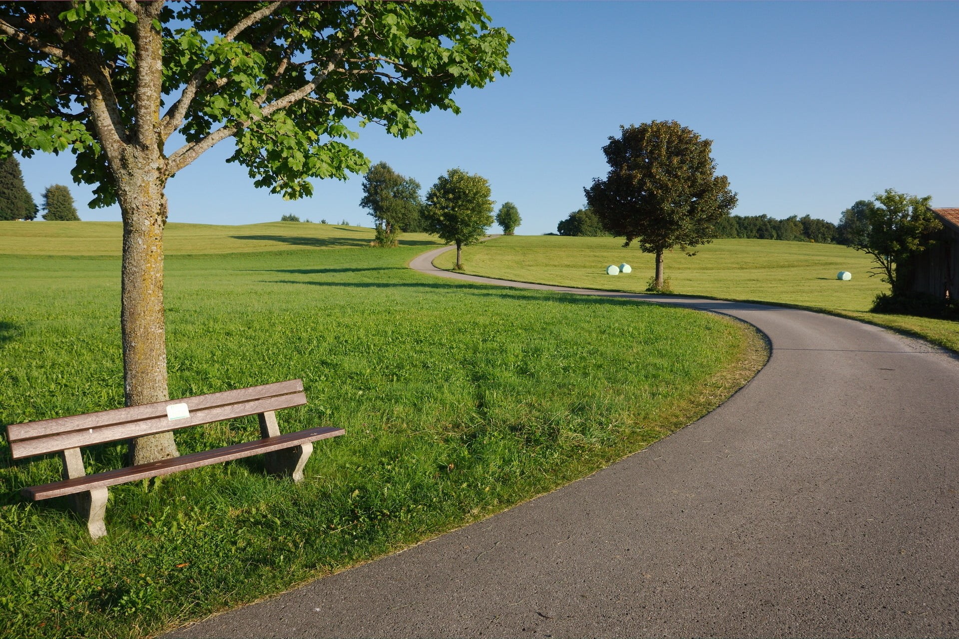 outdoors, clear sky, road, landscape, wooden, tree, landscaped, land, sunlight, sky, green Color, summer, bench, springtime, rural Scene, trees, field, HD Wallpaper