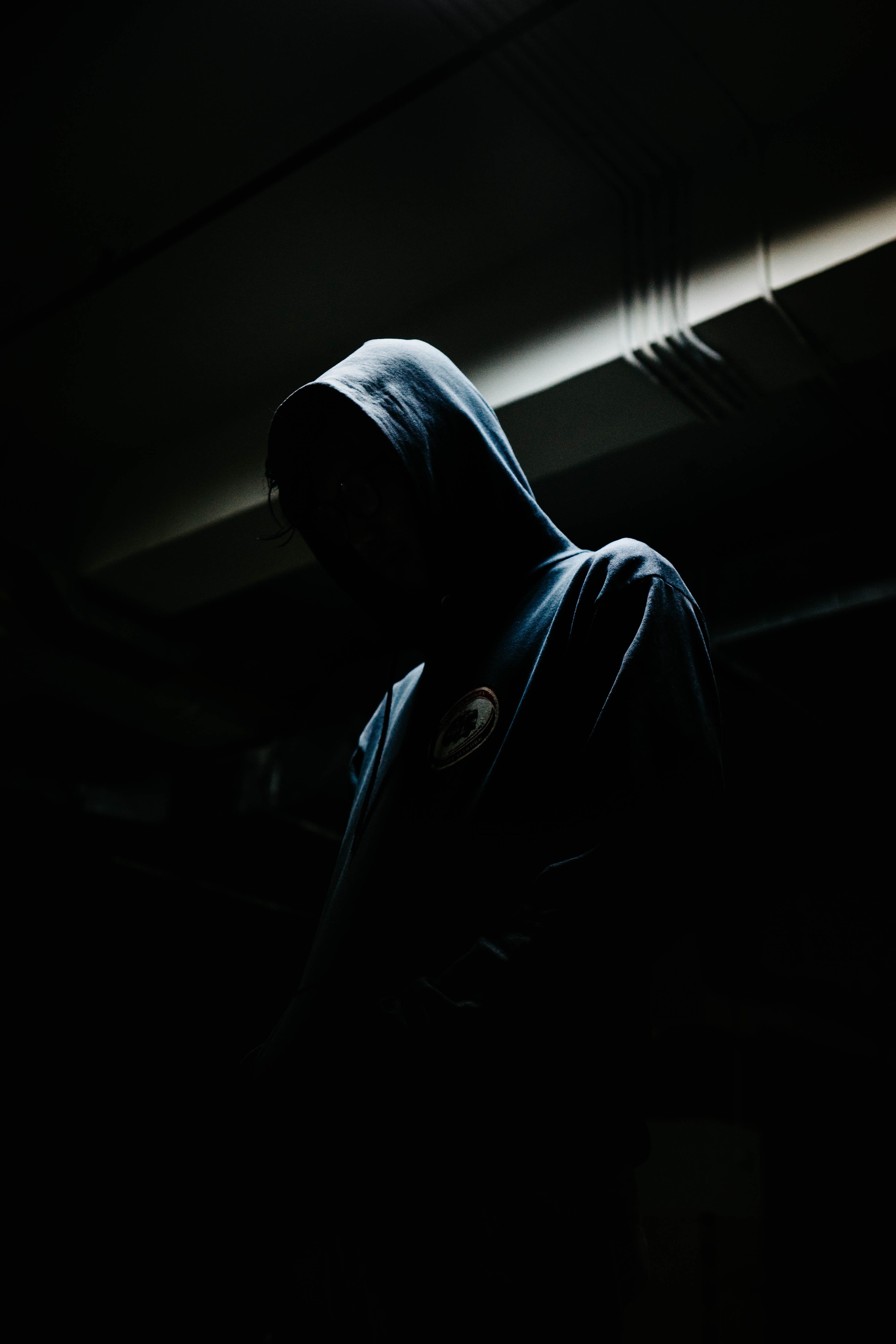 studio shot, person, side view, unrecognizable person, men, standing, motion, black background, indoors, night, hooded shirt, dark, male, one person, hood - clothing, Phone HD Wallpaper
