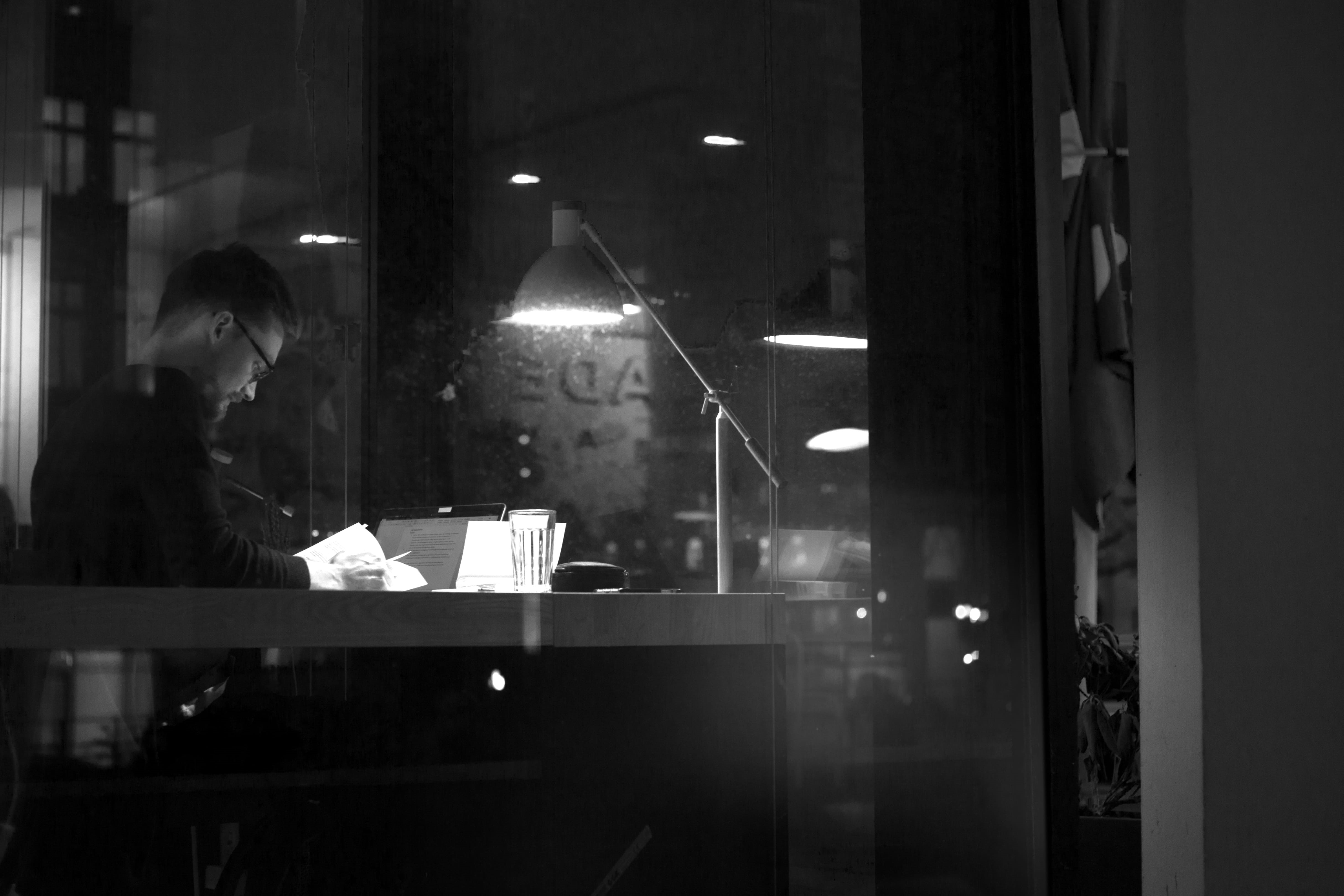 reading, real people, activity, illuminated, night, occupation, lighting equipment, window, light, working, paper, table, 4K, three quarter length, one person, HD Wallpaper
