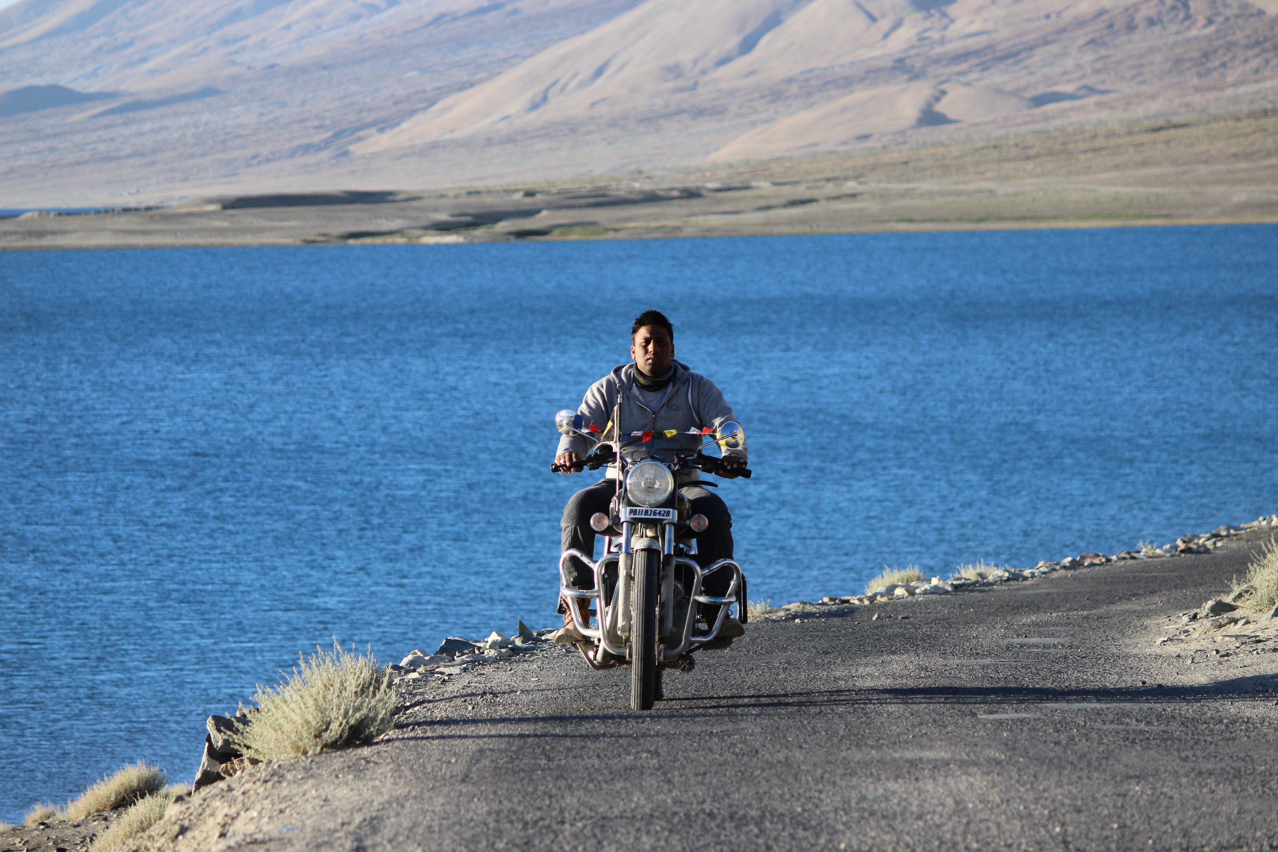 real people, kashmir, himalyan, motorcycle, rider, water, outdoors, pangong, ladakh, lifestyles, day, riding, scenery, helmet, bullet, transportation, beauty in nature, HD Wallpaper