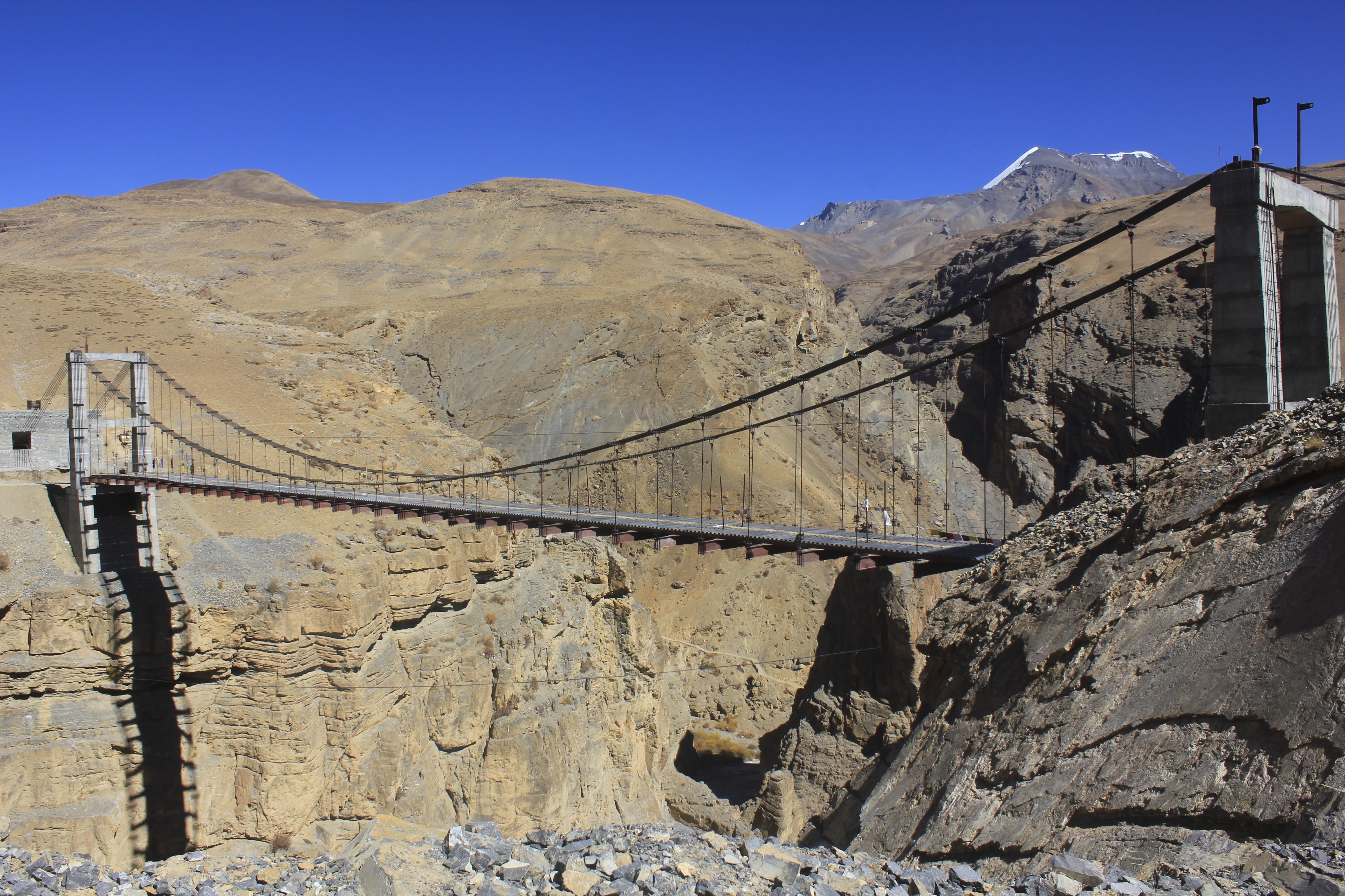 sunlight, landscape, path, clear sky, rock, mountain range, bridge, travel destinations, building exterior, architecture, solid, 5K, built structure, mountain, HD Wallpaper
