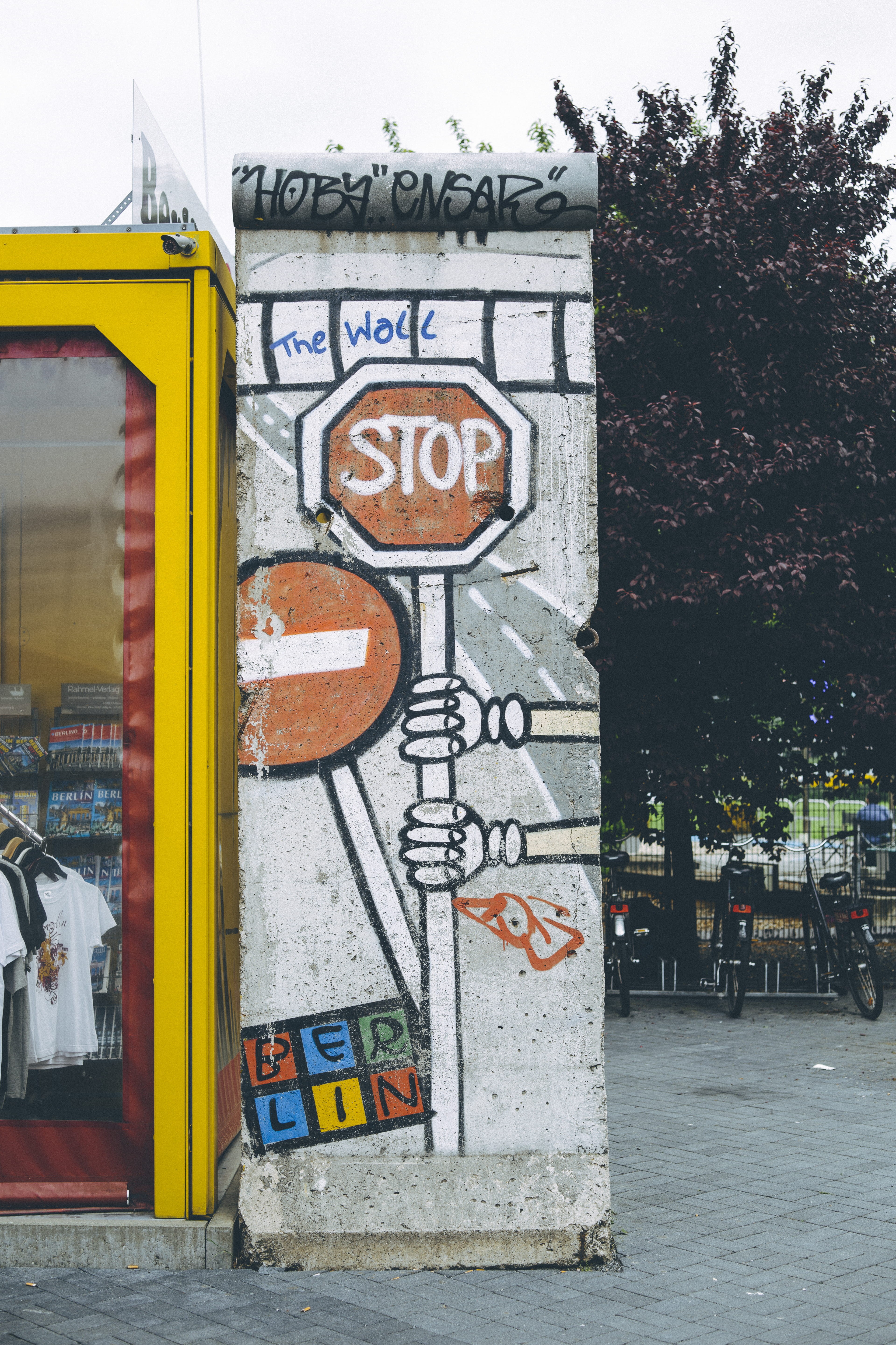 plant, city, stop, tree, stick, sign, wall, day, politic, graffiti, street art, creativity, representation, tower, art, art and craft, berlin, text, building exterior, Phone HD Wallpaper