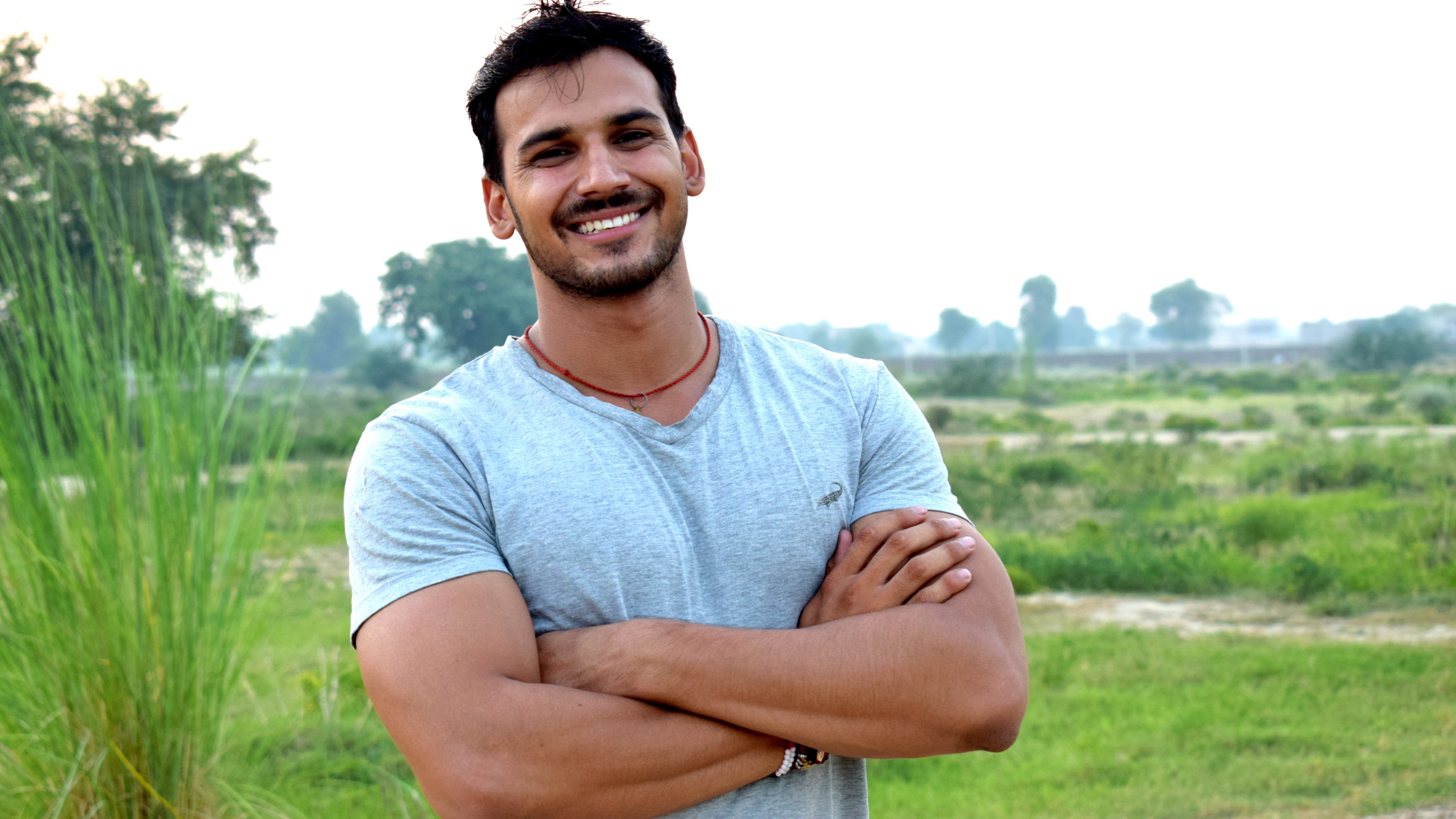 smile, caucasian, one, skin, young, grass, face, head, care, cheerful, standing, man, pose, facial, 5K, hair, fresh, looking at camera, plant, arms crossed, HD Wallpaper