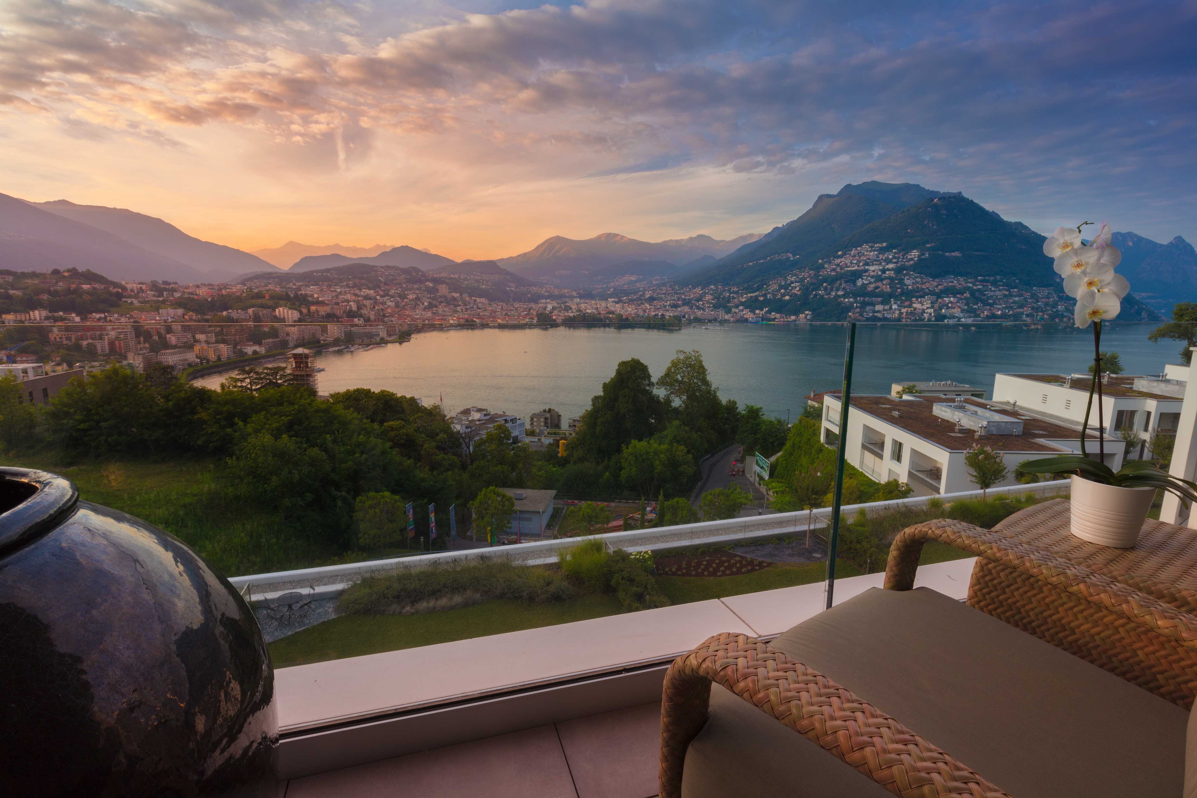 built structure, hotel, sunset, outdoors, flower, flower pot, tree, lake, mountain range, view, mountain, cloud - sky, villa, city, tranquil scene, scenics - nature, HD Wallpaper