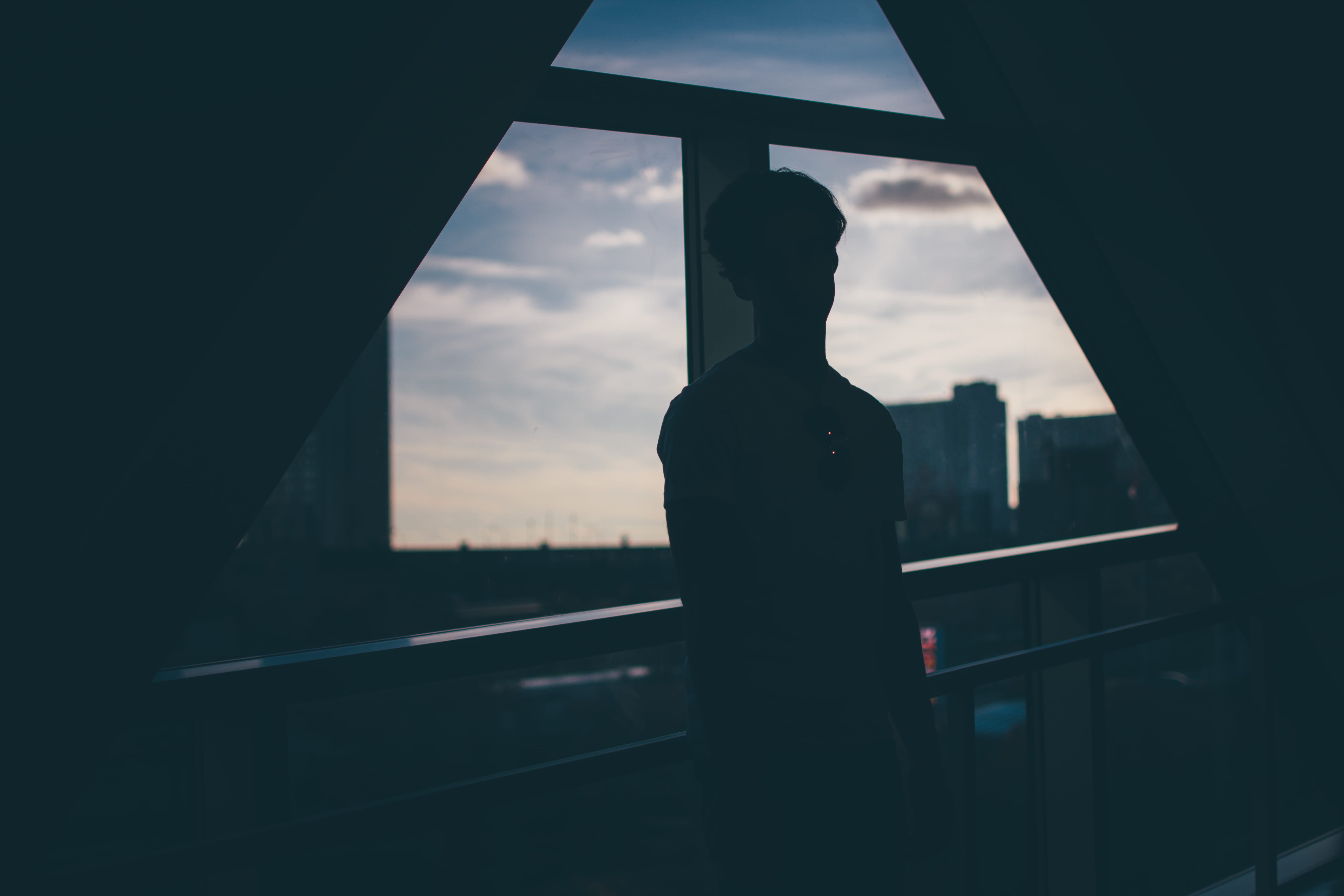 dark, wall, 5K, person, transparent, cloud - sky, hour, sunset, sky, built structure, beside, man, window, near, rails, leaning, glass - material, city, HD Wallpaper
