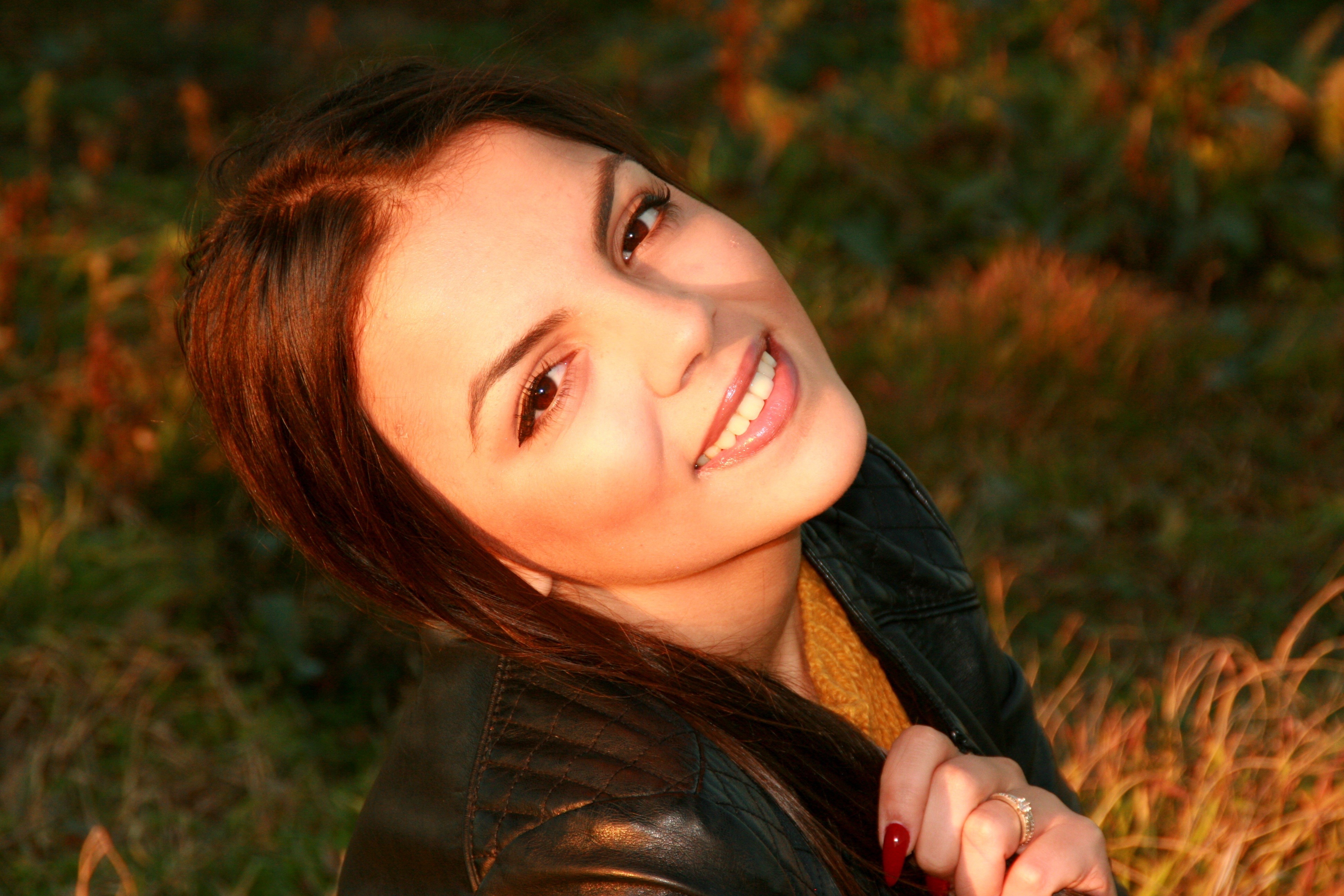 smiling, long hair, autumn, hair, holding, happiness, cheerful, woman, leather, women, wearing, leather jacket, real people, nature, headshot, beautiful woman, HD Wallpaper