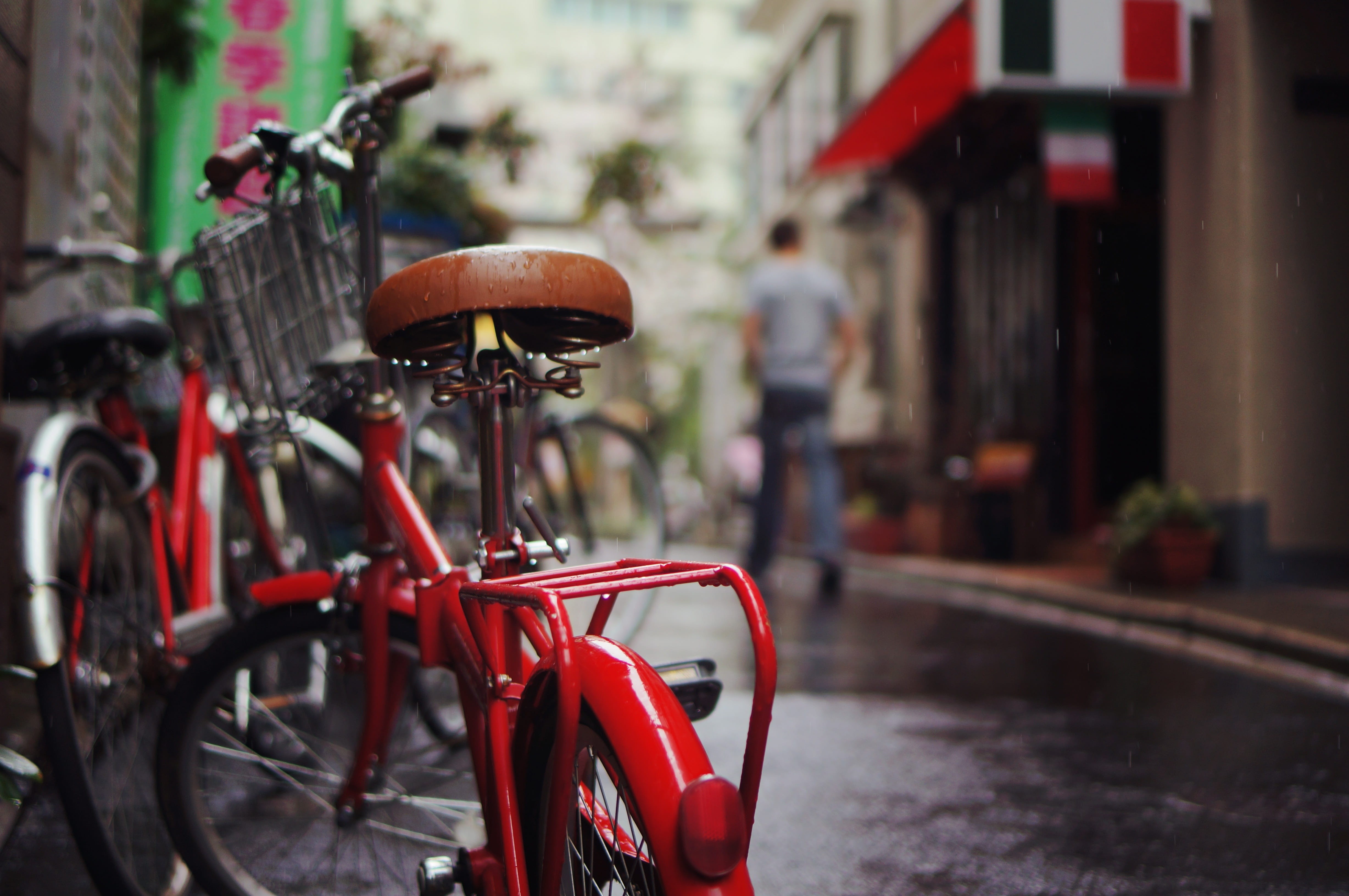 land vehicle, close-up, incidental people, mode of transportation, building exterior, folding, parked, rainy, wheel, built structure, folding bike, focus, HD Wallpaper