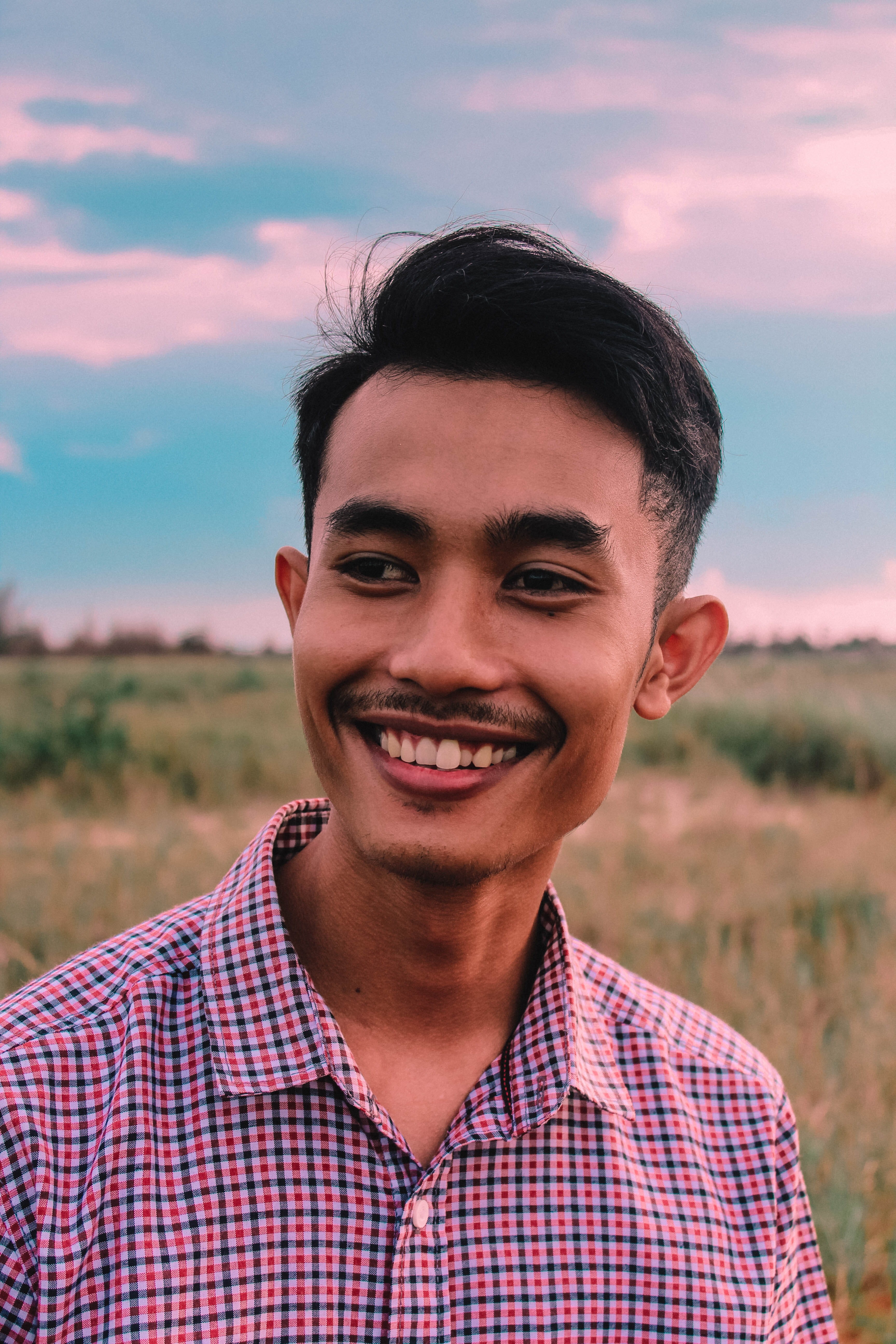 model, casual clothing, emotion, candid, outdoors, .man, pink, 5K, young adult, one person, smiling, closeup, lifestyles, landscape, happiness, moustache, Phone HD Wallpaper