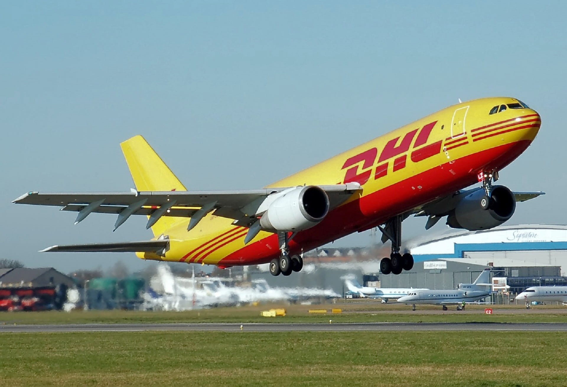 fly, grass, taking, yellow, travel, air vehicle, airline, flying, motion, jet, transportation, clear sky, environment, dhl airlines, no people, leaving, HD Wallpaper