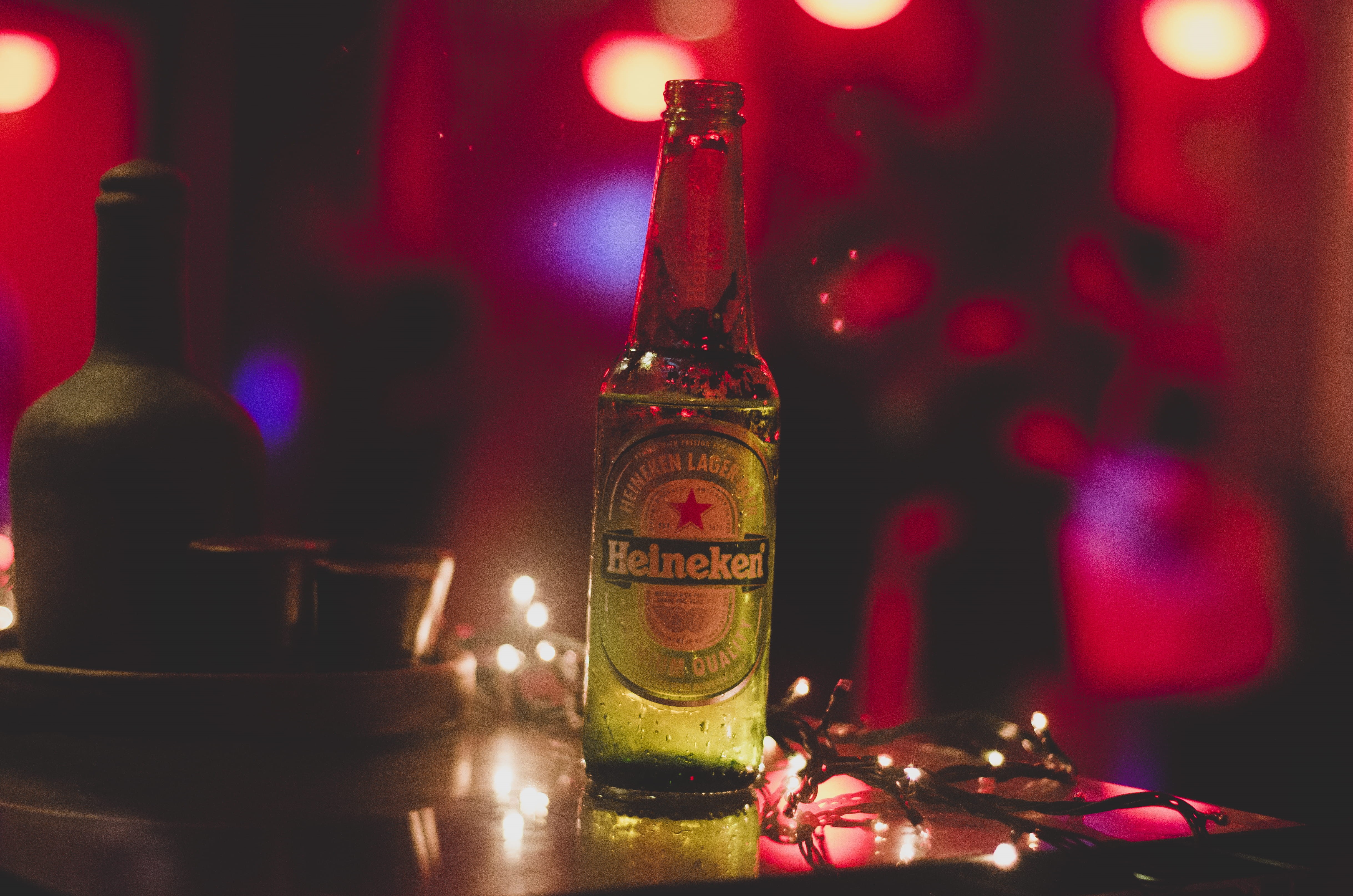 4K, glass, drink, food and drink, red, celebration, lights, christmas lights, Heineken, no people, string lights, refreshment, bottles, label, beer, focus on foreground, HD Wallpaper
