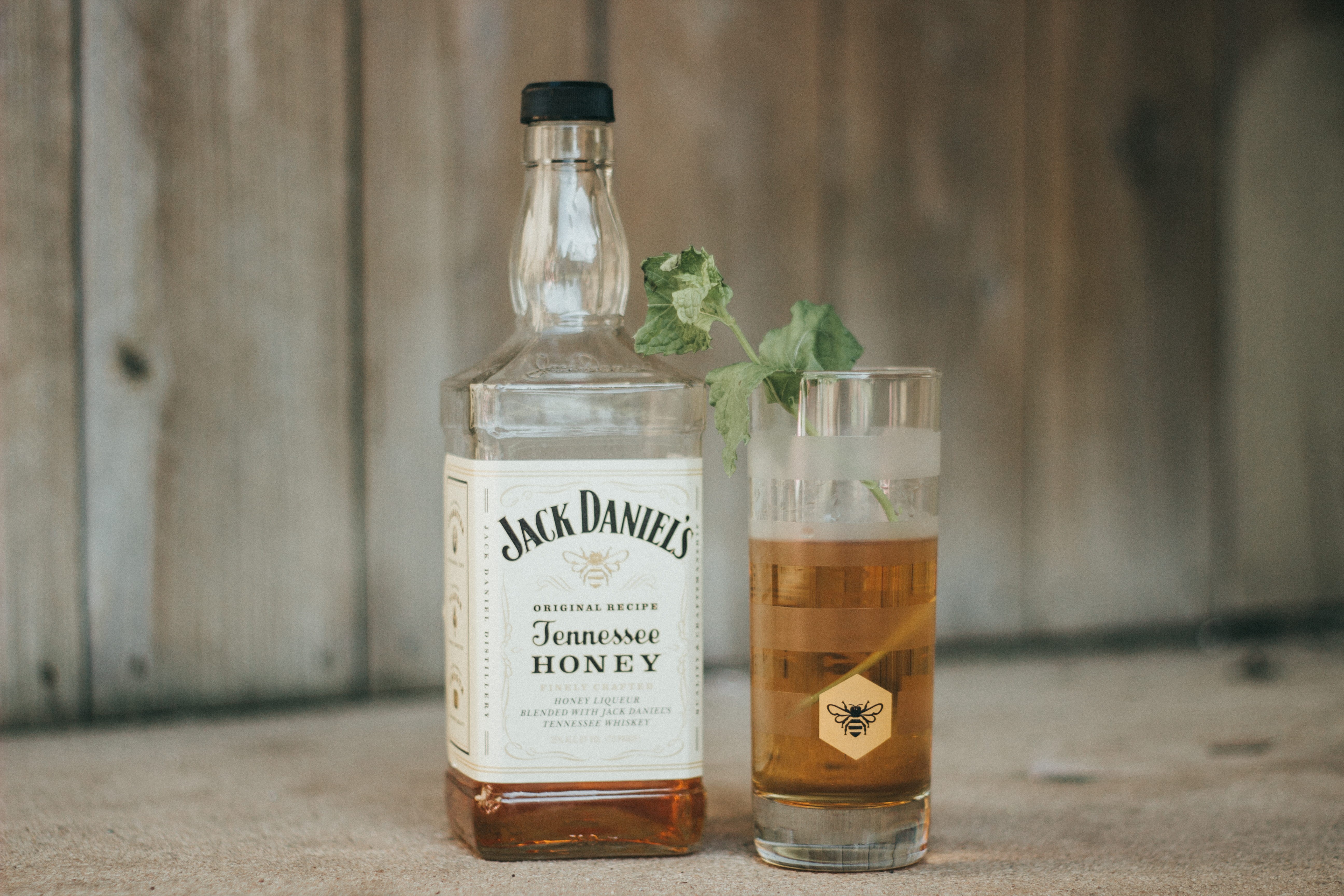 daniels, close-up, herb, 5K, indoors, transparent, glass - material, honey, container, western script, food and drink, whisky, fence, jack daniels, focus on foreground, HD Wallpaper