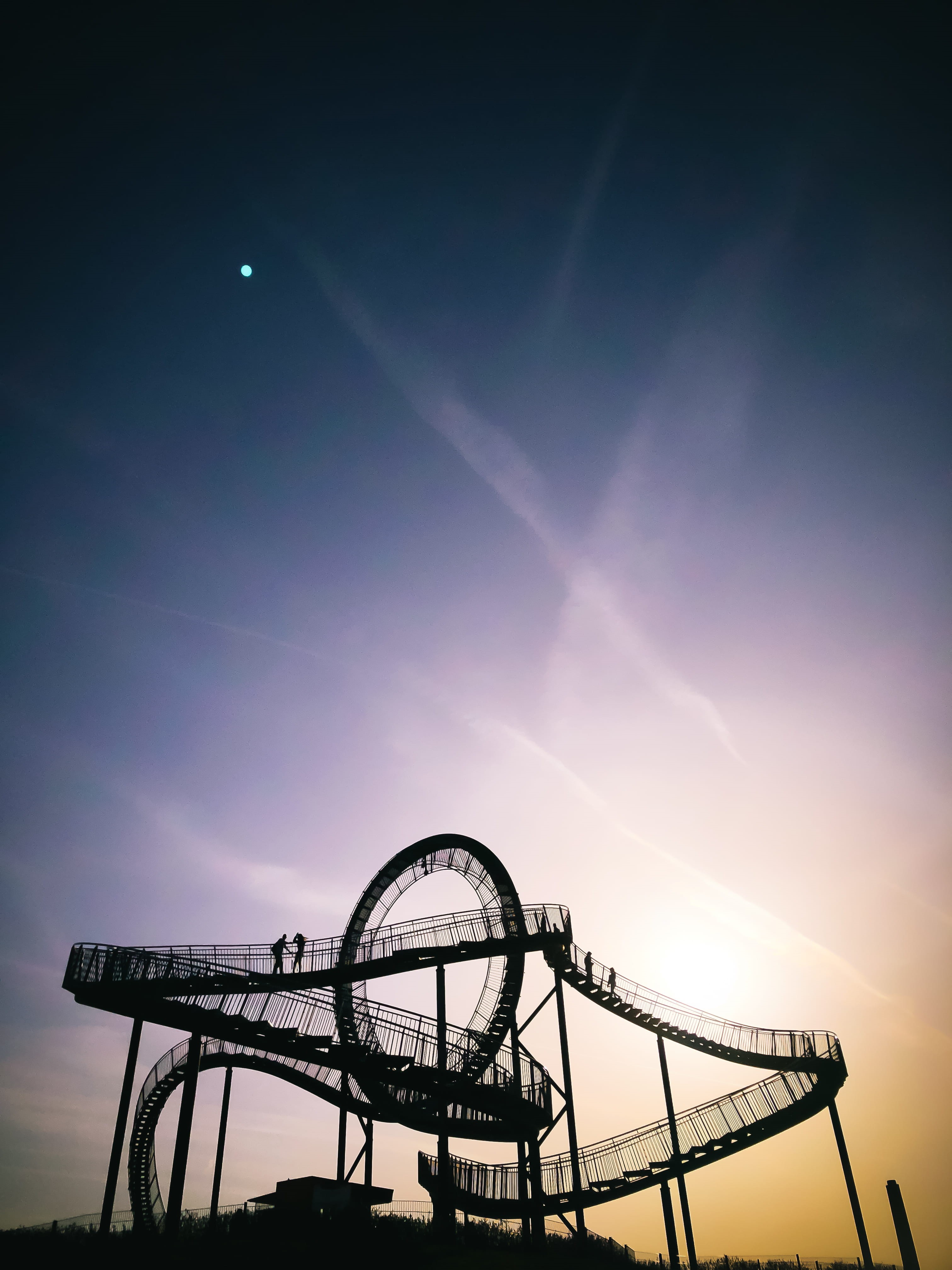 leisure activity, architecture, top, ride, rollercoaster, roller coaster, explore, silhouette, magis mountain, sun, deutschland, sunset, tiger and turtle, Phone HD Wallpaper