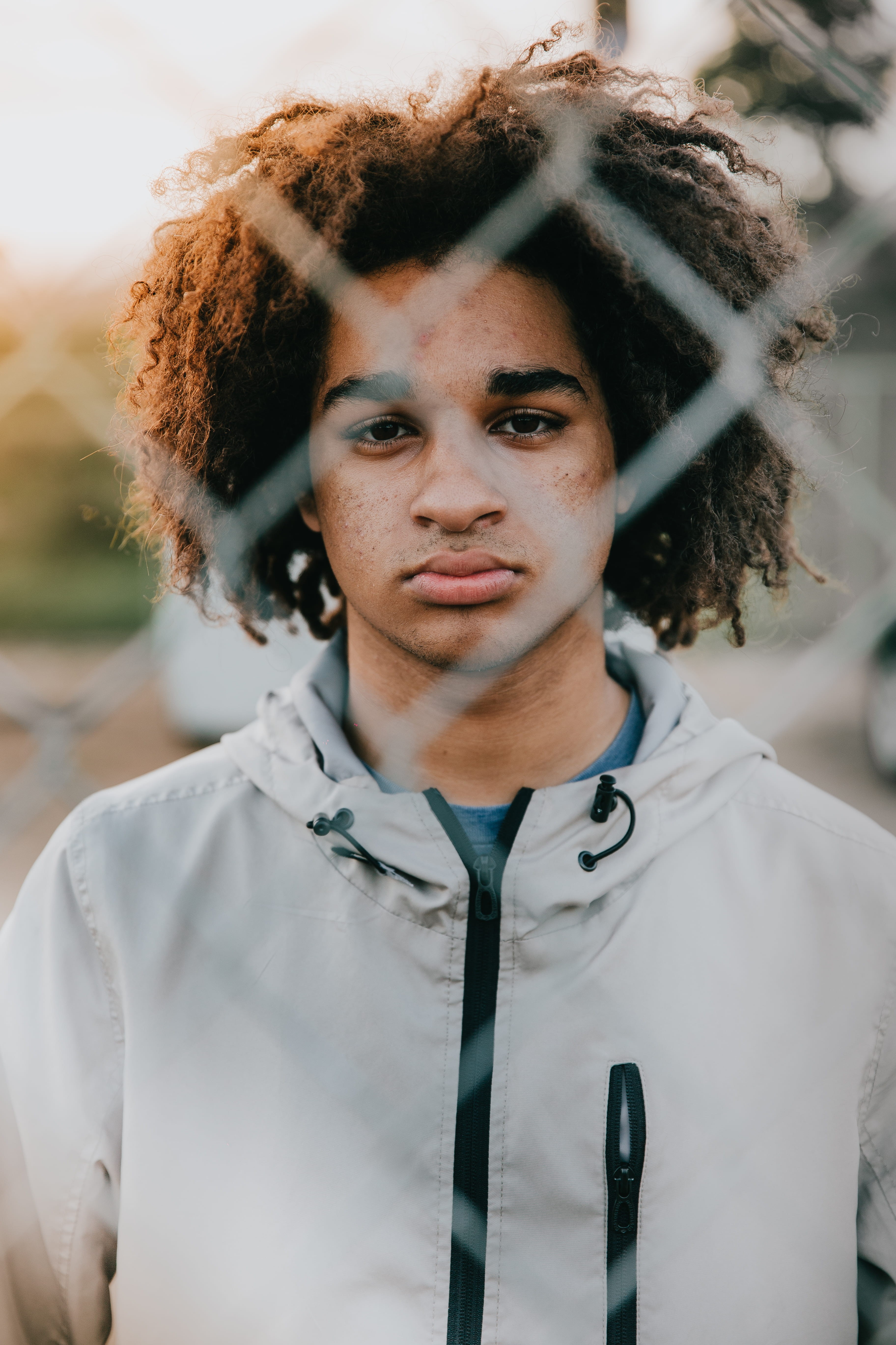 focus on foreground, year, curly hair, lifestyles, one person, face, person, fence wall, sad face, adult, real people, senior, portrait, looking at camera, Phone HD Wallpaper