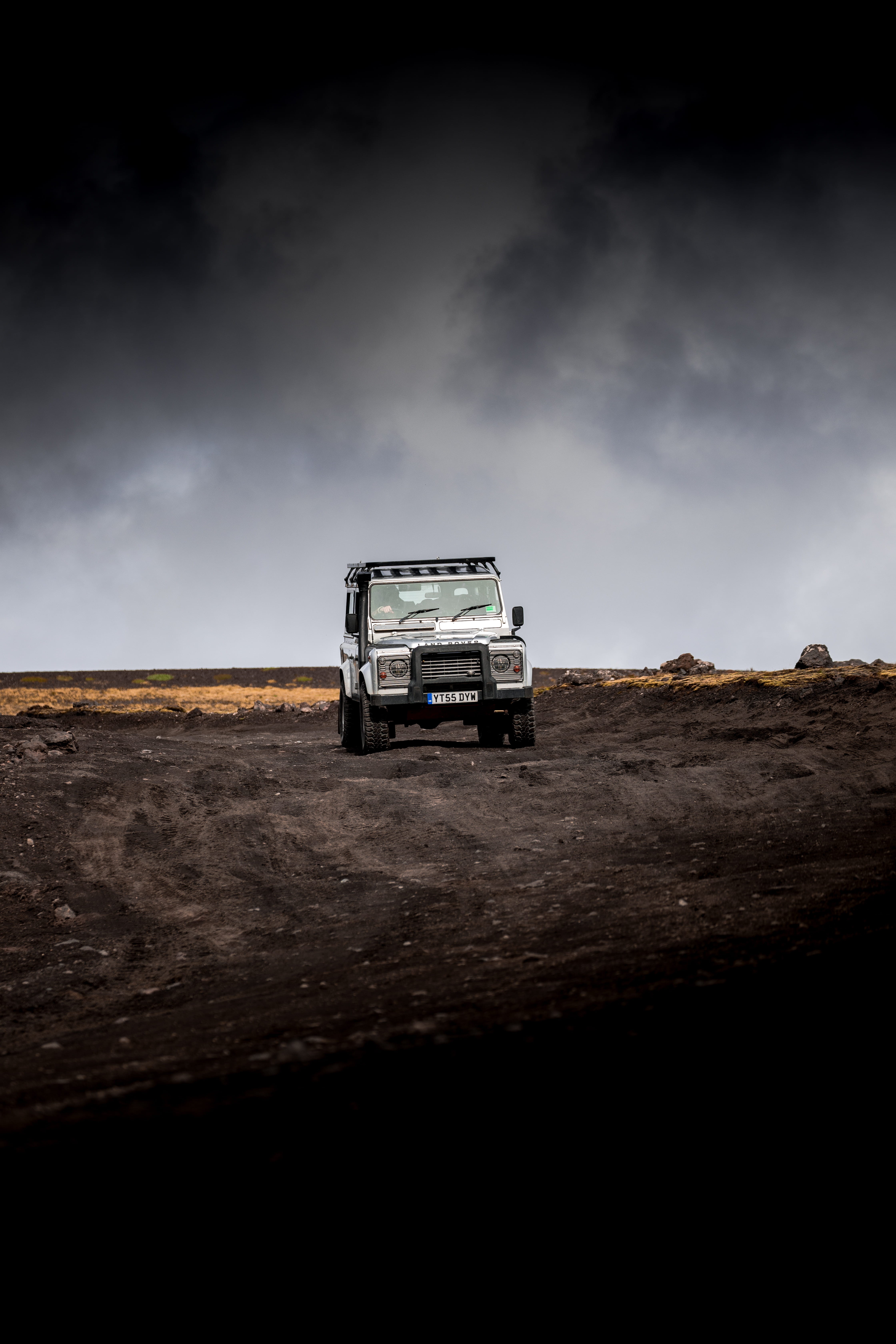 terrain, black Color, vehicle, wheel, car, dirt, roadtrip, dark, landscape, competition, 5K, tire, rain, rock, mountain, sky, land Vehicle, outdoors, driving, Phone HD Wallpaper