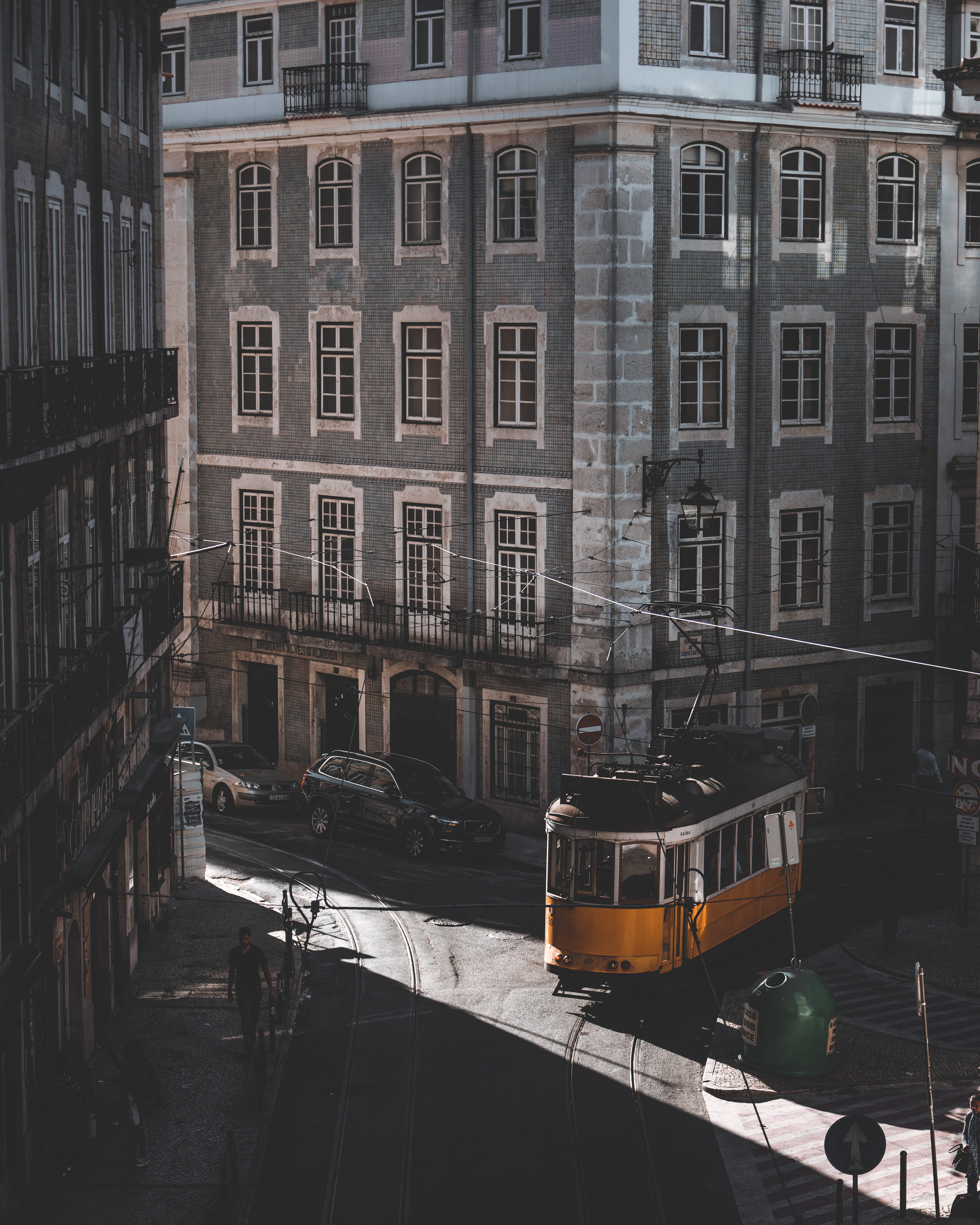 urban, 4K, public transportation, tram, high angle view, cables, window, residential district, vehicle, school bus, no people, roaming, architecture, yellow, Phone HD Wallpaper